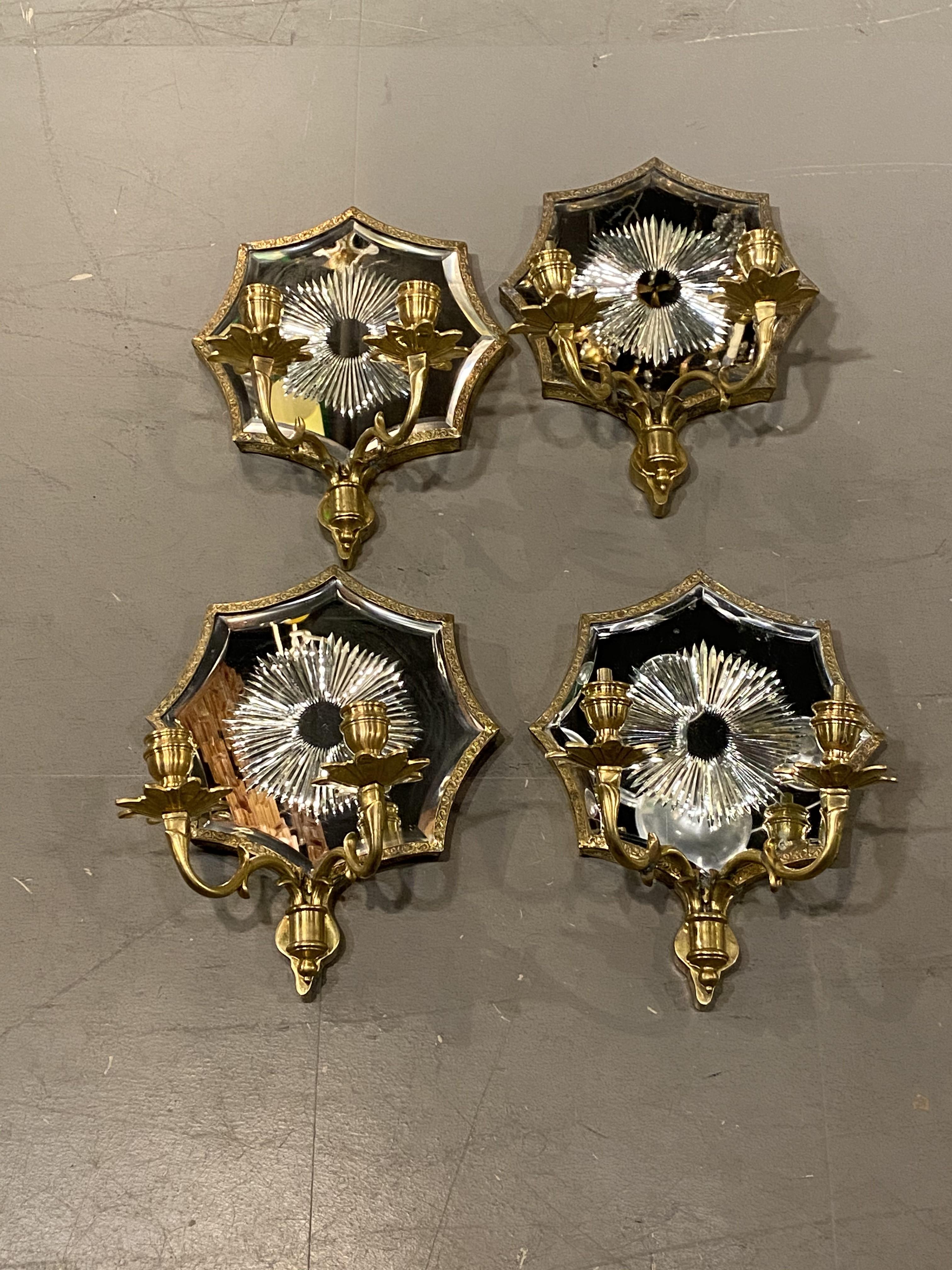 A pair of circa 1920's Caldwell double light sconces with sunburst etched mirrored backplate