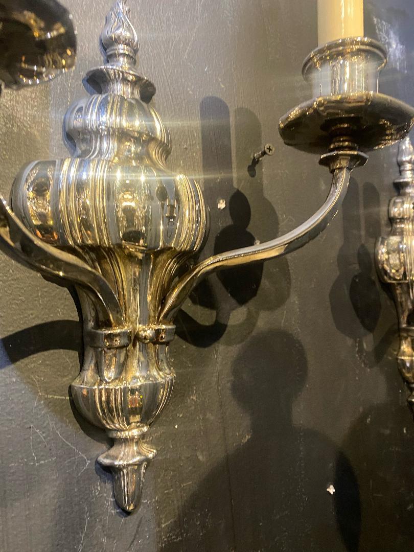 A pair of circa 1920's silver plated Caldwell sconces with two lights