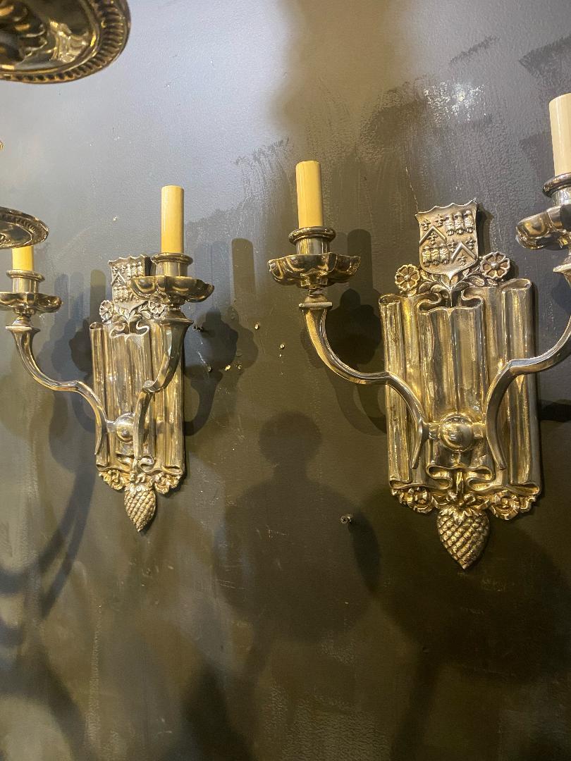 A pair of circa 1920's Caldwell silver plated sconces with two lights, original finish.