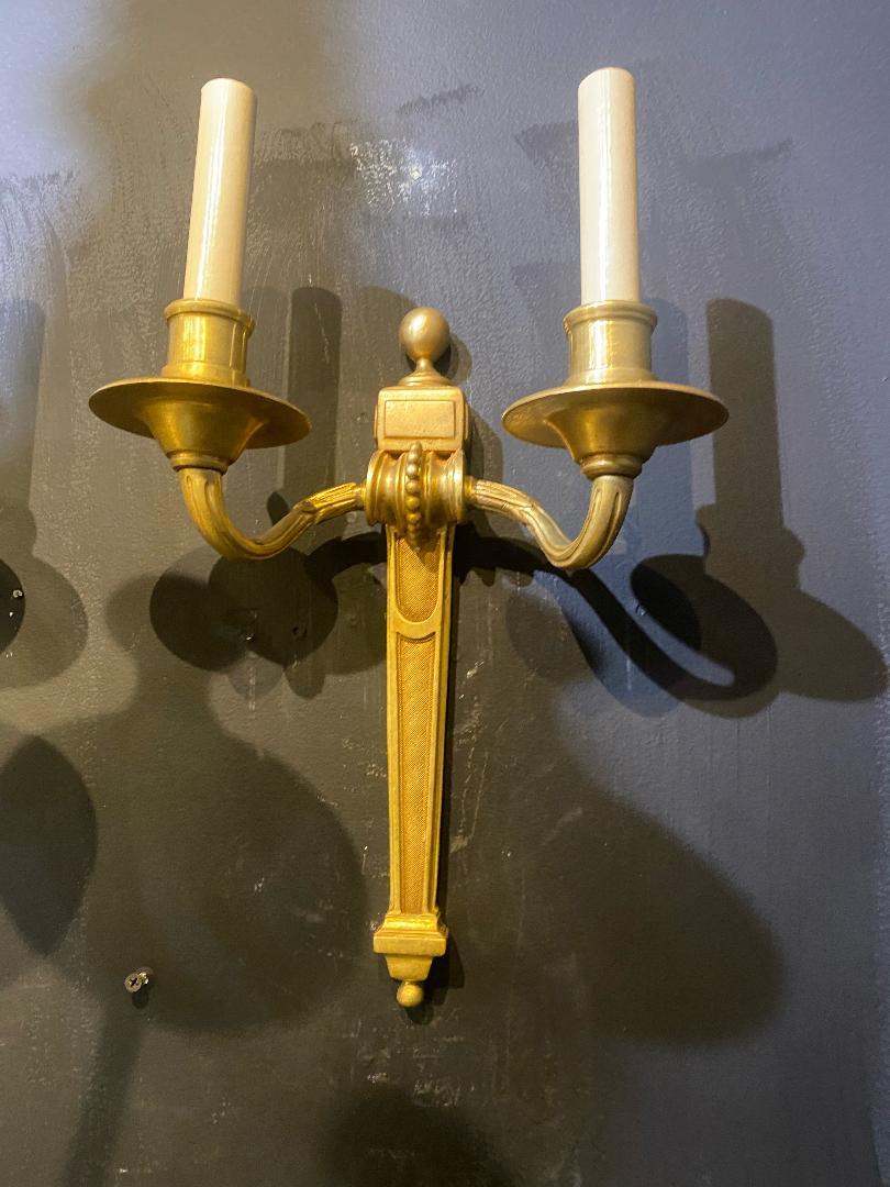 A pair of circa 1920's gilt bronze Caldwell sconces with two lights