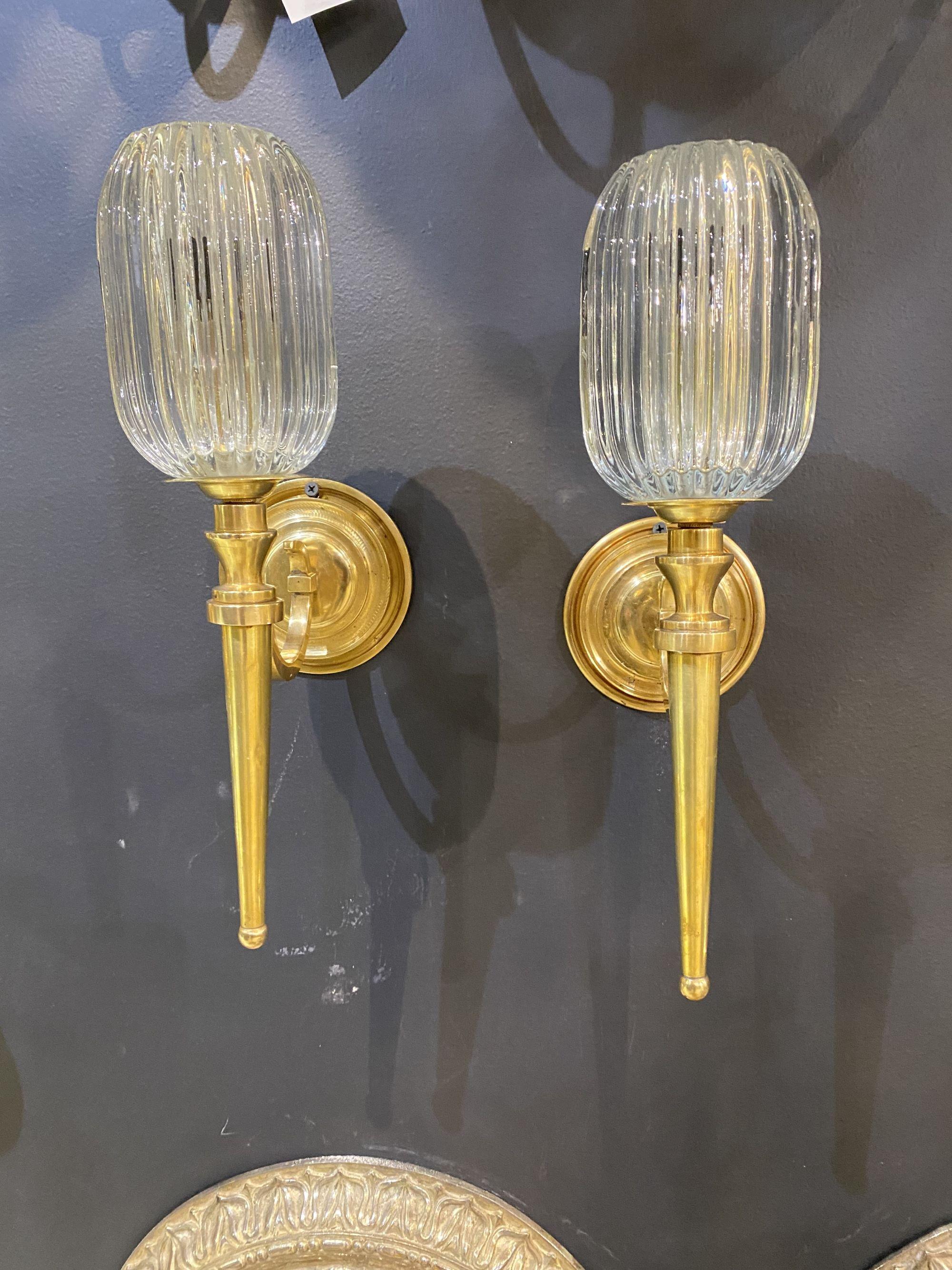 a pair of circa 1920's Caldwell one light sconces with reeded glass shade.