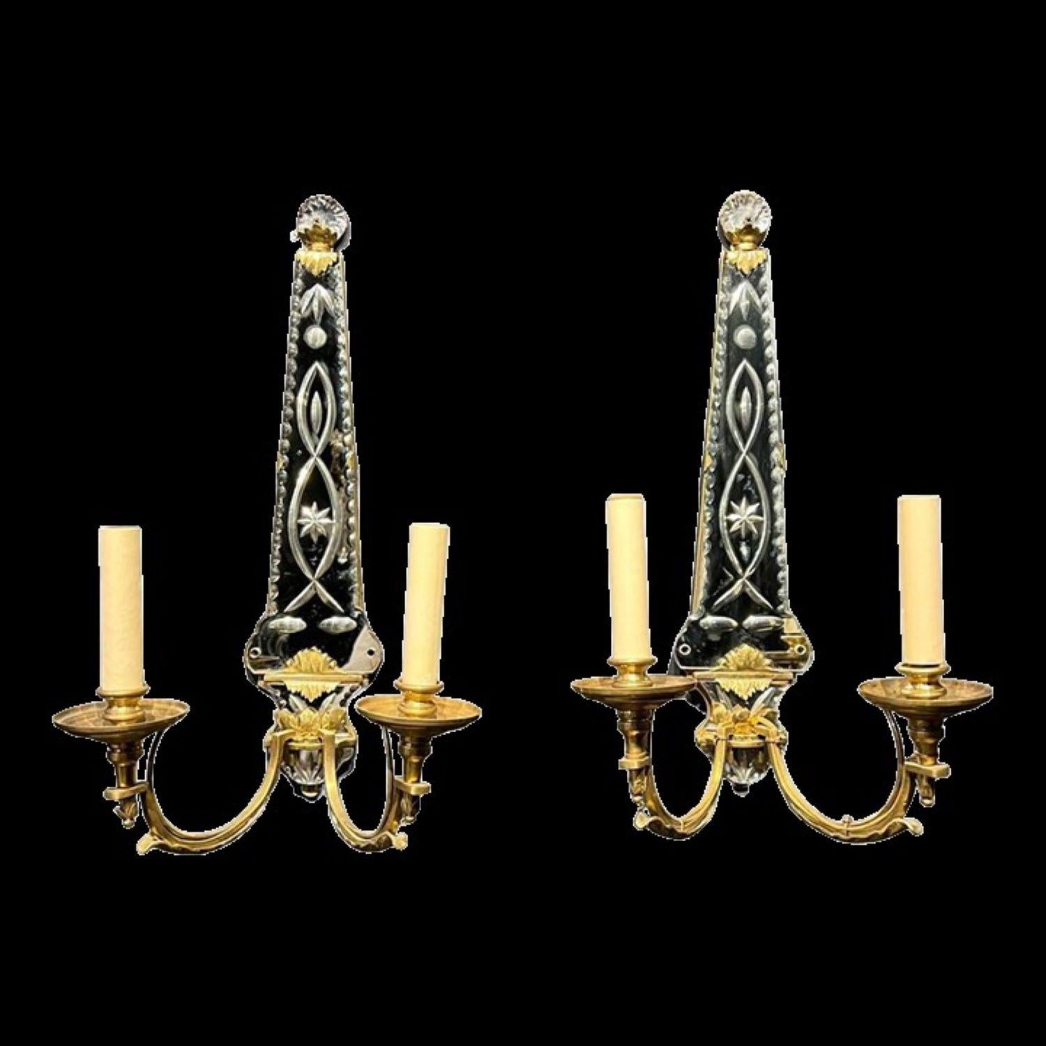 A pair of circa 1920's French gilt bronze sconces with etched mirrored backplate
