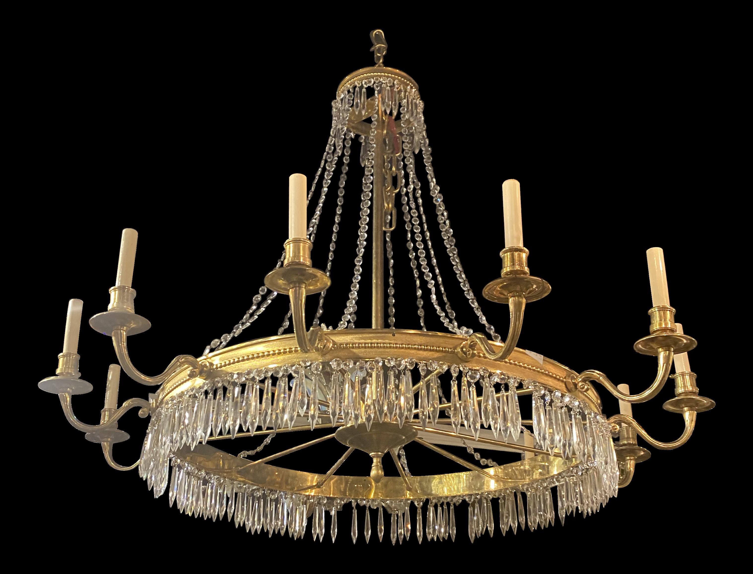 A circa 1930's French gilt bronze 12 lights chandelier with crystals hangings
