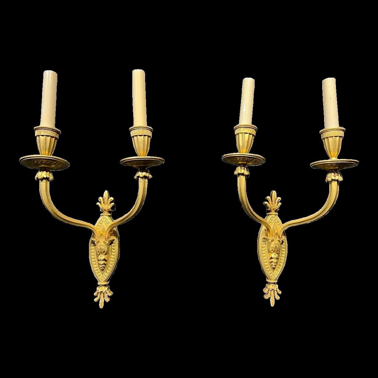 A pair of circa 1930's gilt bronze double light sconces. Original finish and patina