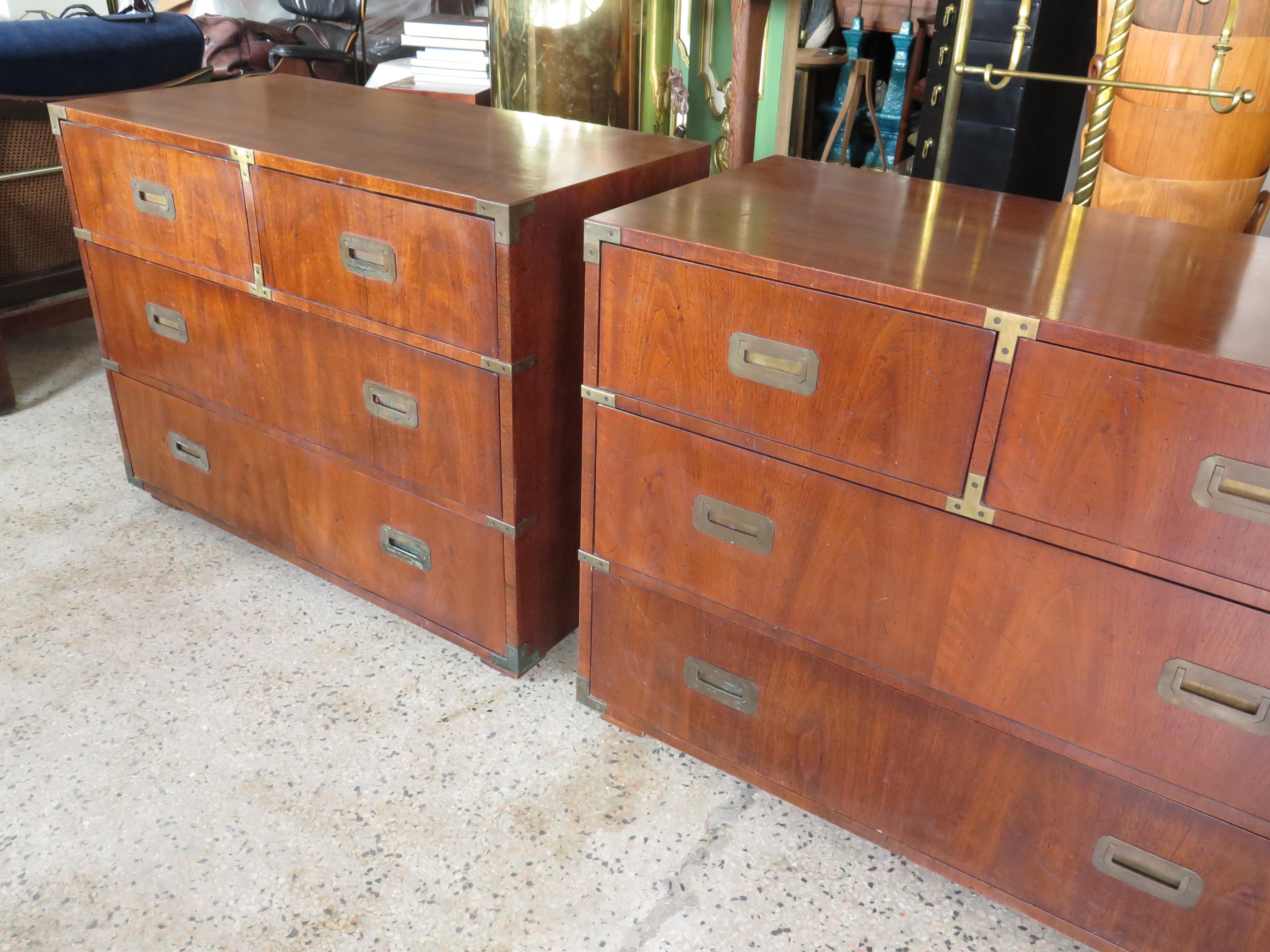 A pair of campaign style dressers by Henredon. Walnut with solid brass handles and accents. Well made and heavy, original patina and finish. At 39