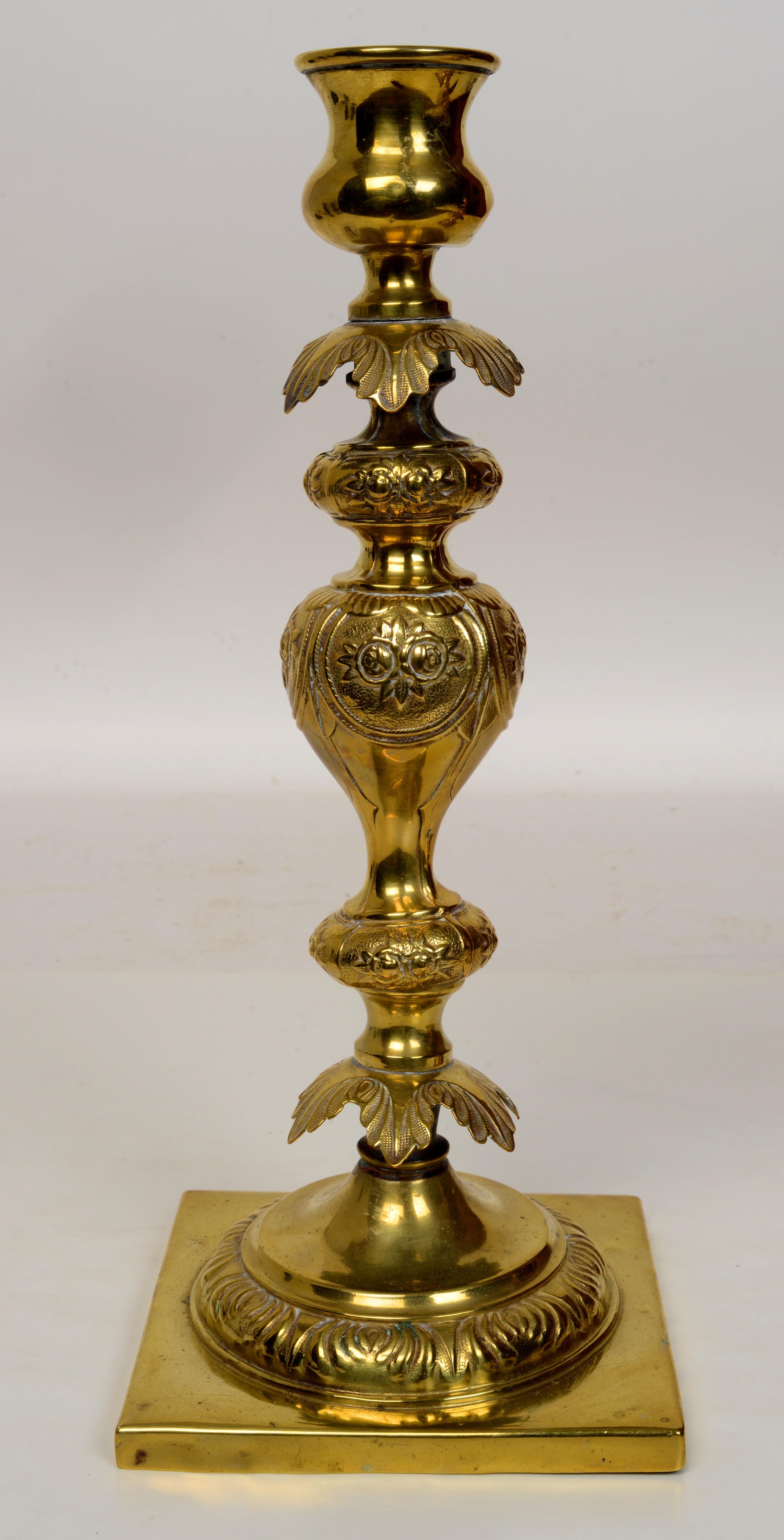  A Pair of Classic Polish Sabbath Candlesticks, Late 19th c, by B. Henneberg Warszawie (Warsaw.) With chased, foliate and linear ornamentation. These candlesticks were a highly prized possession and were passed down to daughters or daughter-and-laws