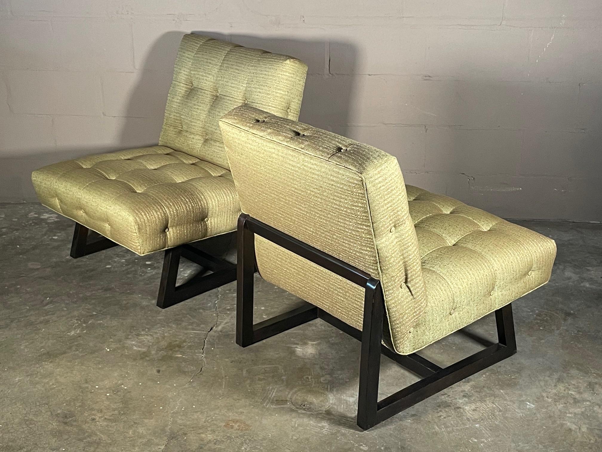 A great pair of slipper chairs ca' early 1950's. Dark brown frames, reupholstered in period green/brown fabric.