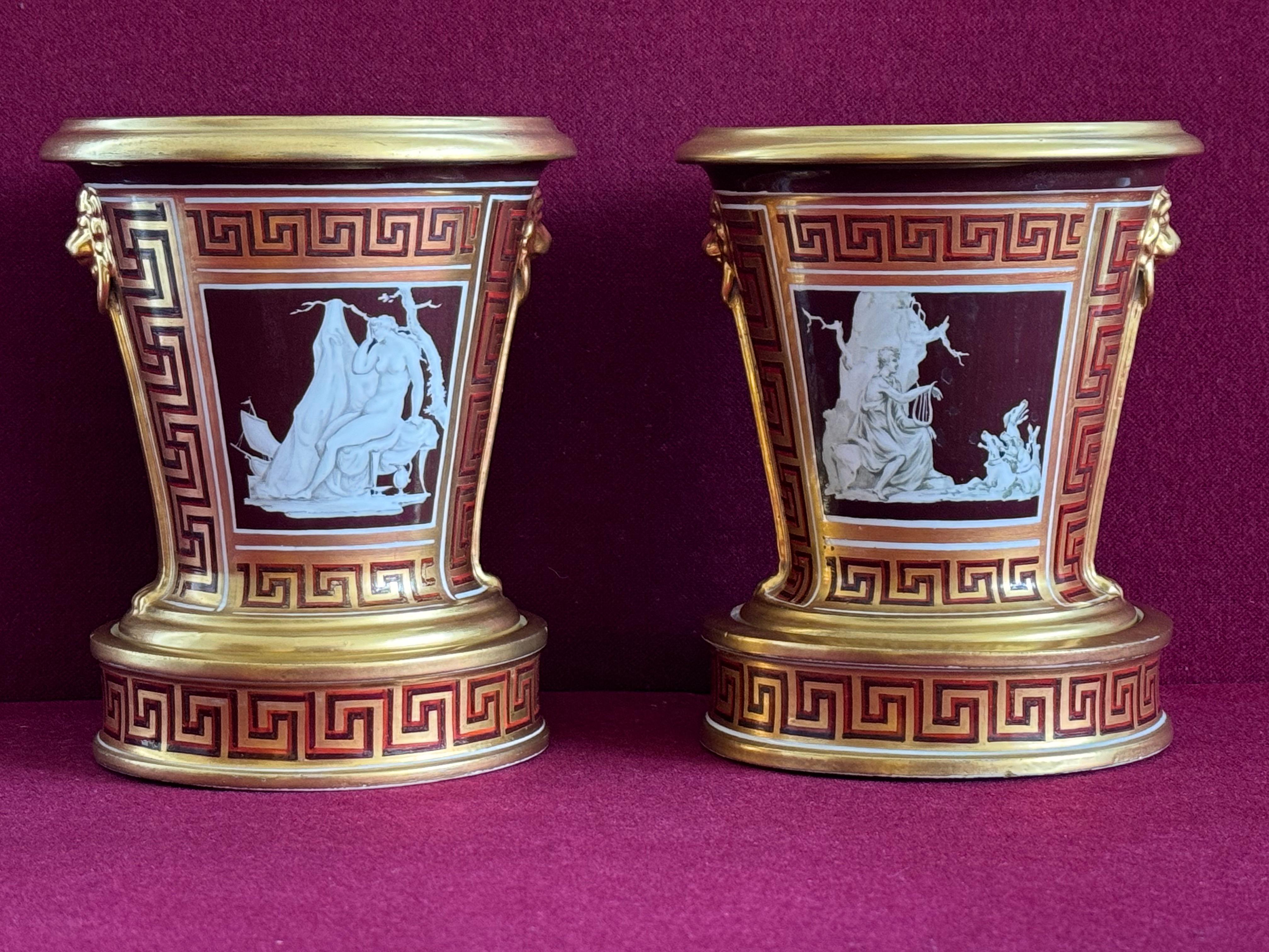 A rare pair of Coalport porcelain cache pots c.1802-1805. Each cache pot, painted in the London studio of Thomas Baxter most probably by Thomas Baxter junior, ‘en grisaille’ with classical scenes depicting Ariadne abandoned by Theseus and Orpheus