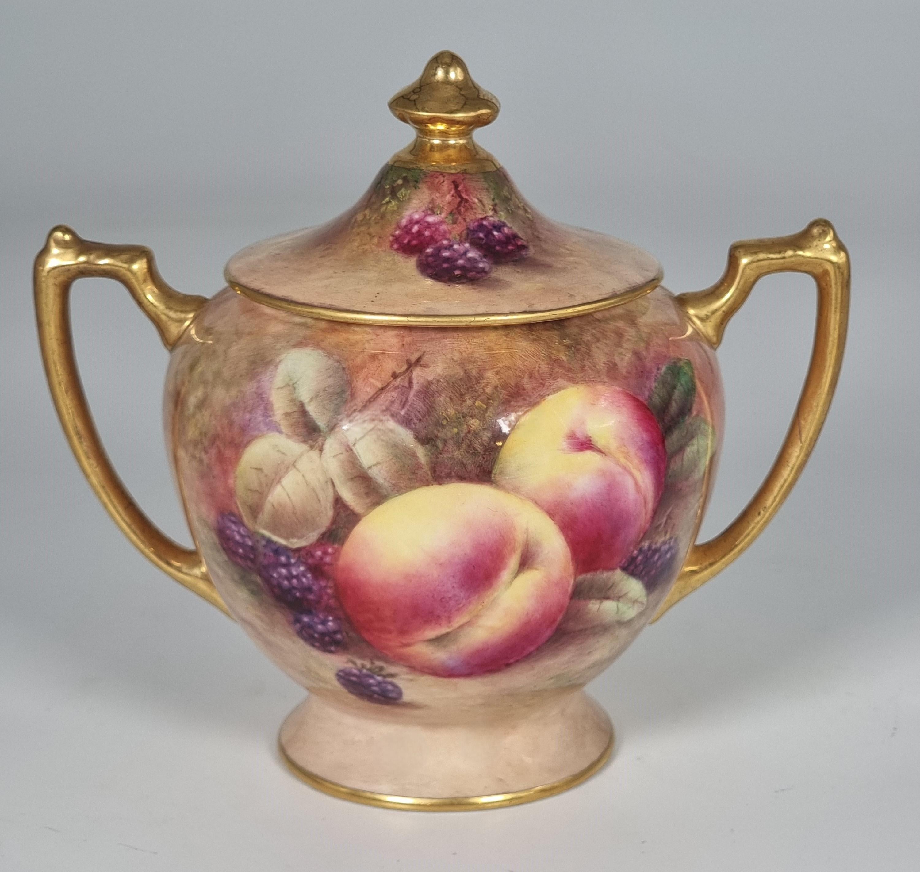 Une paire de vases à deux anses en porcelaine de Coalport avec couvercles est magnifiquement peinte à la main avec des fruits sur une rive moussue par Richard Budd qui a également peint pour Royal Worcester.

Les vases sont mis en valeur par de