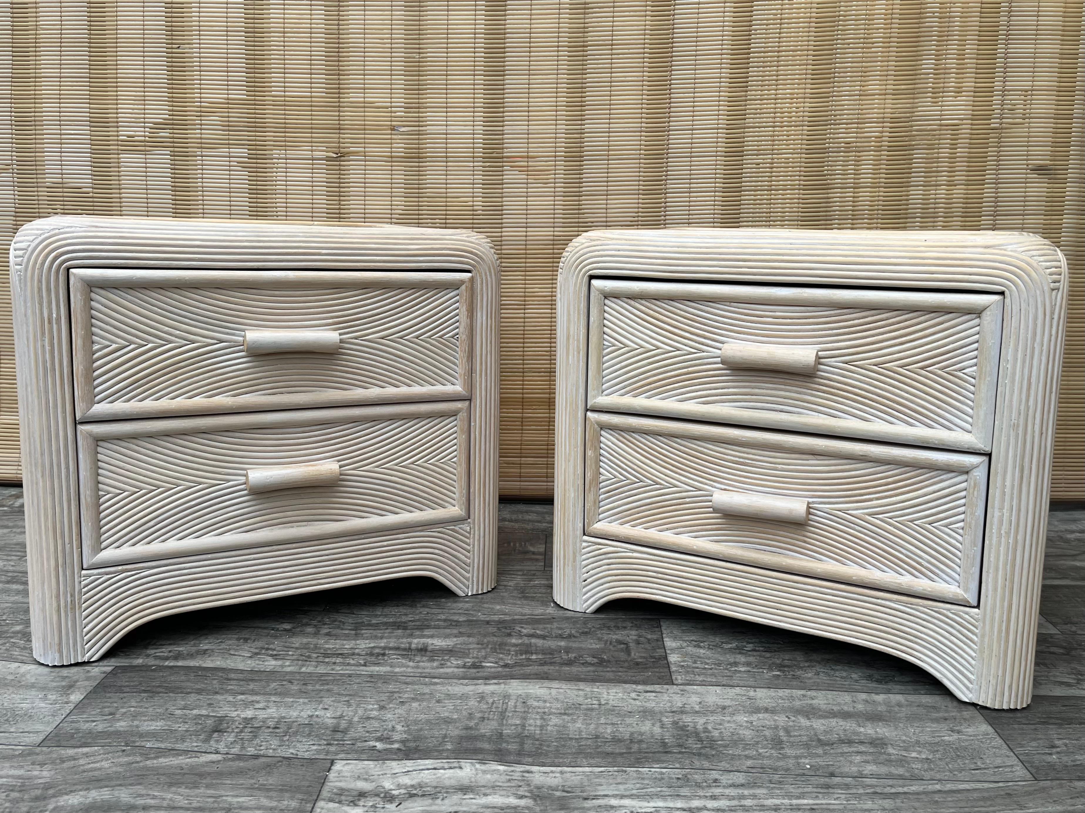 A Pair of Coastal Style Split Reed Rattan Nightstands. Circa 1980s
Feature a chic rattan and split pencil reed swirl pattern design with rounded corners in a beautiful soft cream color with two drawers that offer plenty of storage space.
In