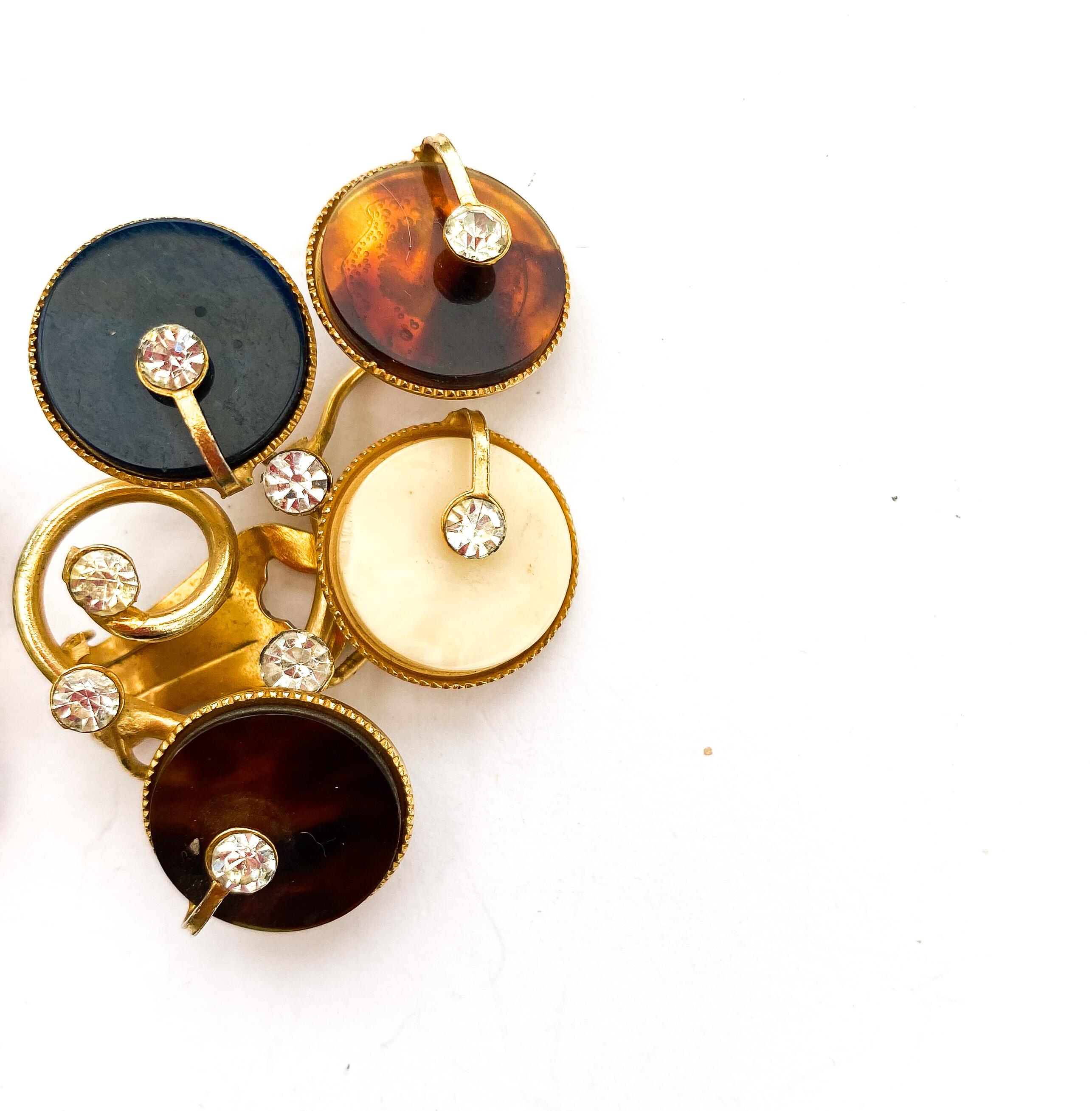 These beautiful earrings are highly individual and stylised but immediately eye catching. Very typical of Italian design during this period. An unusual colour combination, mixing plastic with clear paste, and softly gilded metal make these truly