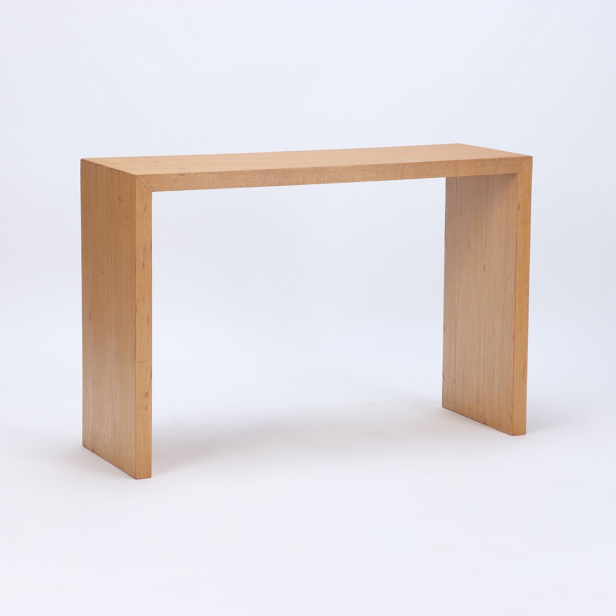 A pair of contemporary cerused oak console tables.