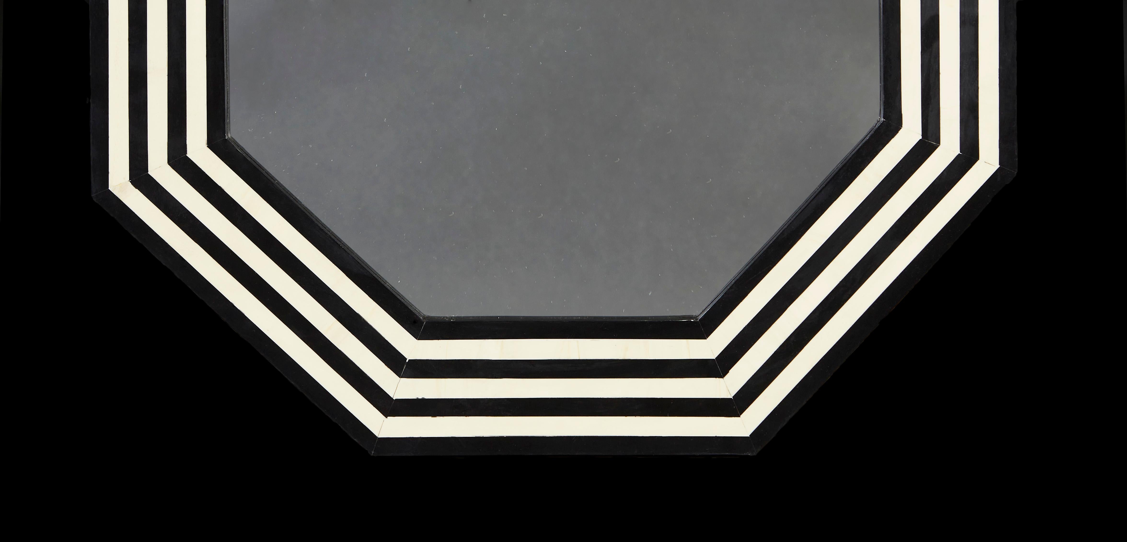 A pair of contemporary black and white geometric mirrors of octagonal form.