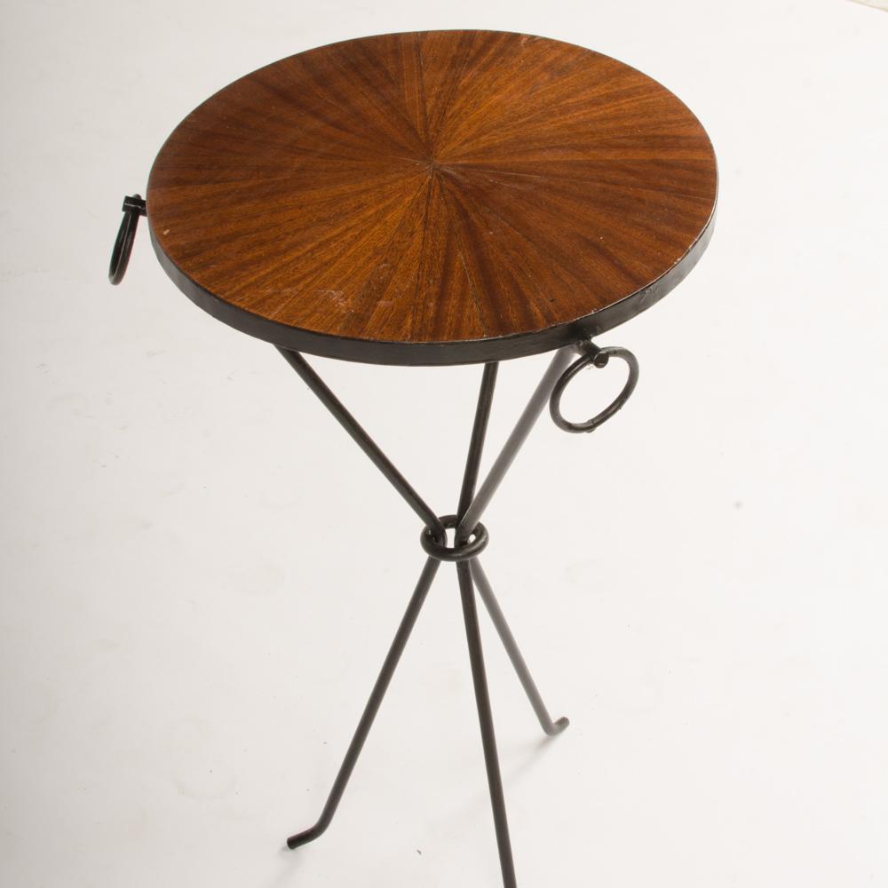 A pair of wrought iron drink tables with parquet tops and three iron rings. The tables rest on a sleek tripod form base.