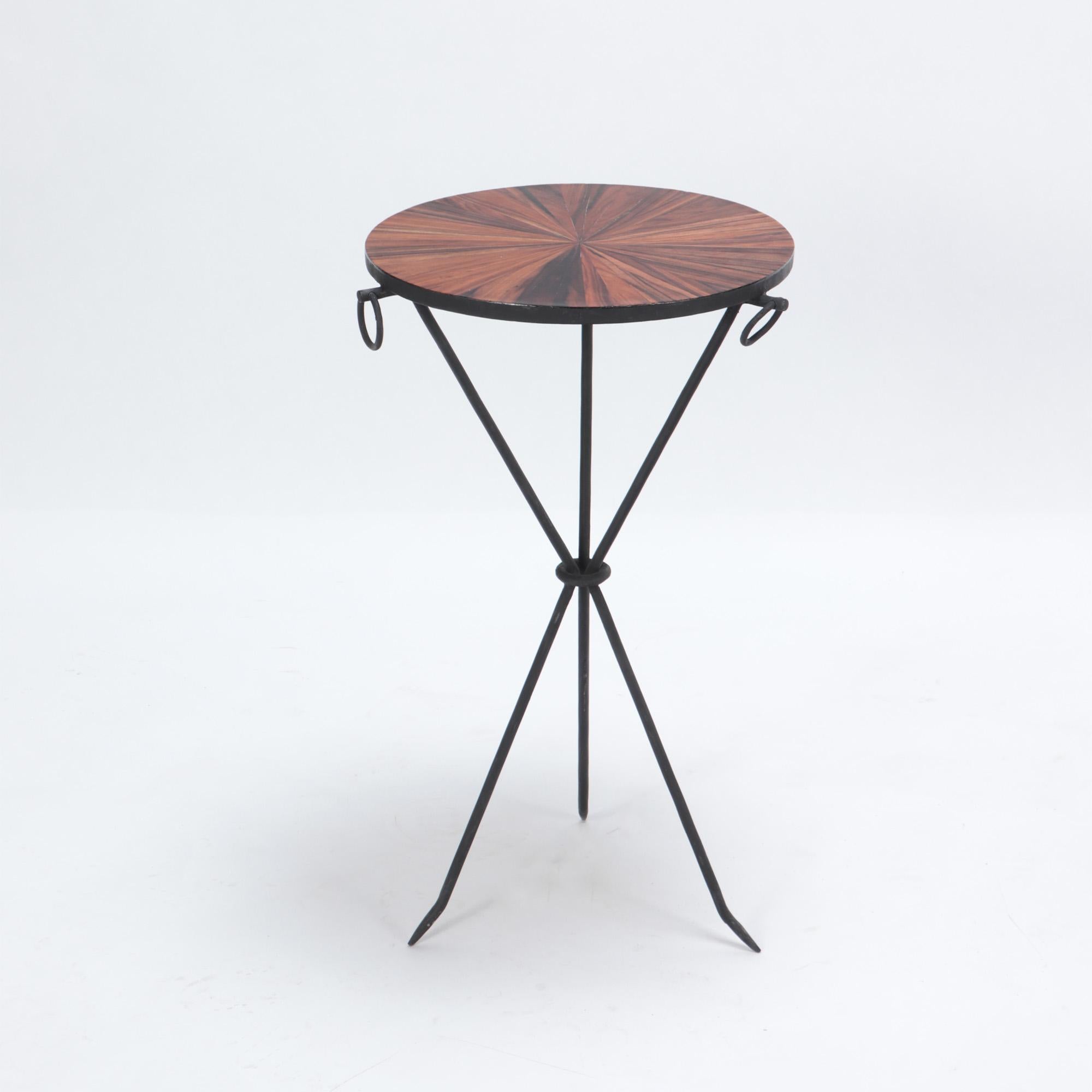A pair of wrought iron drink tables with parquet tops and three iron rings. in the manner of Jean-Michel Frank. The tables rest on a sleek tripod form base.