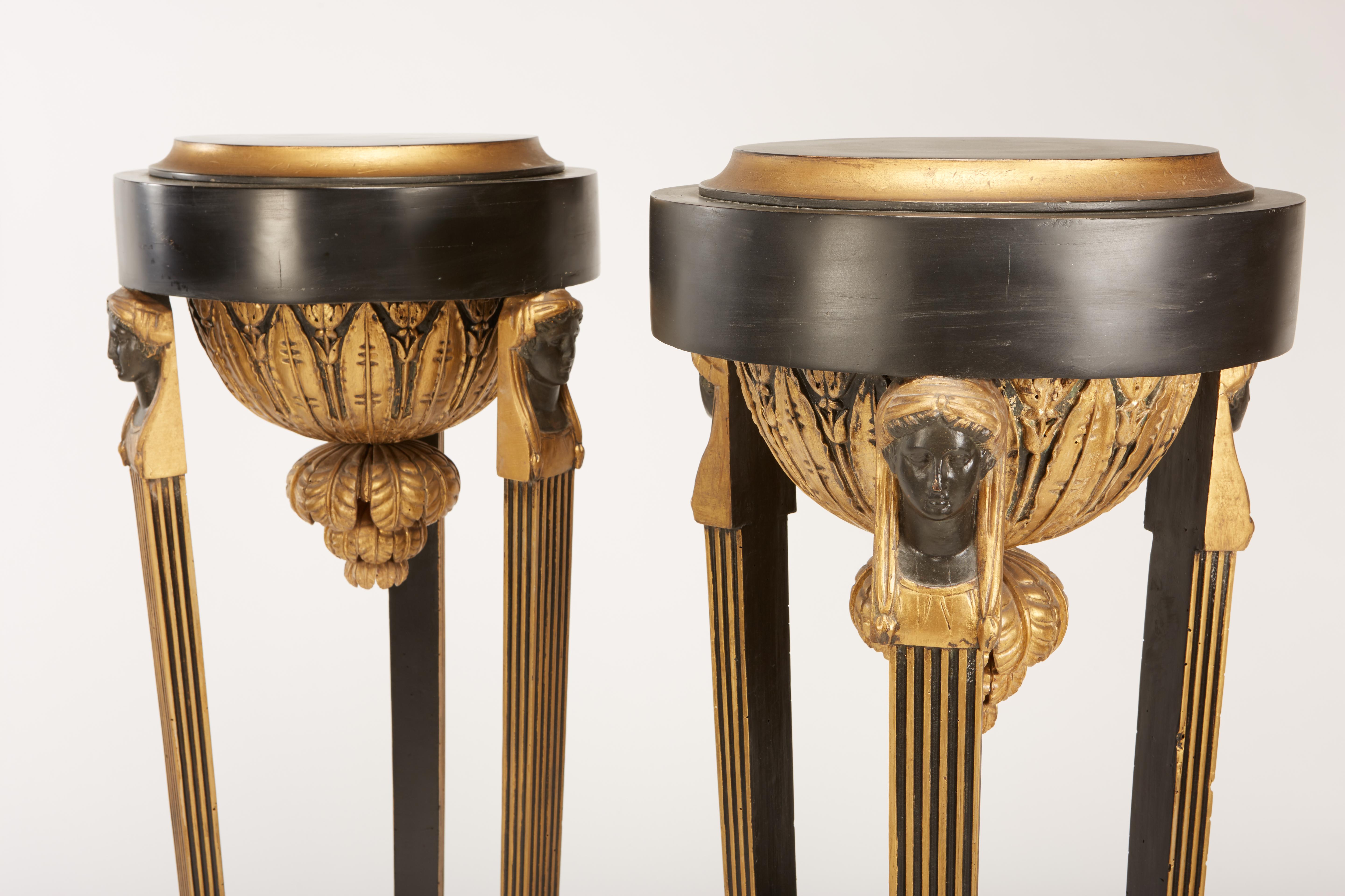 Neoclassical Pair of Continental Neoclassic Black Painted and Parcel-gilt Torcheres, Italian For Sale