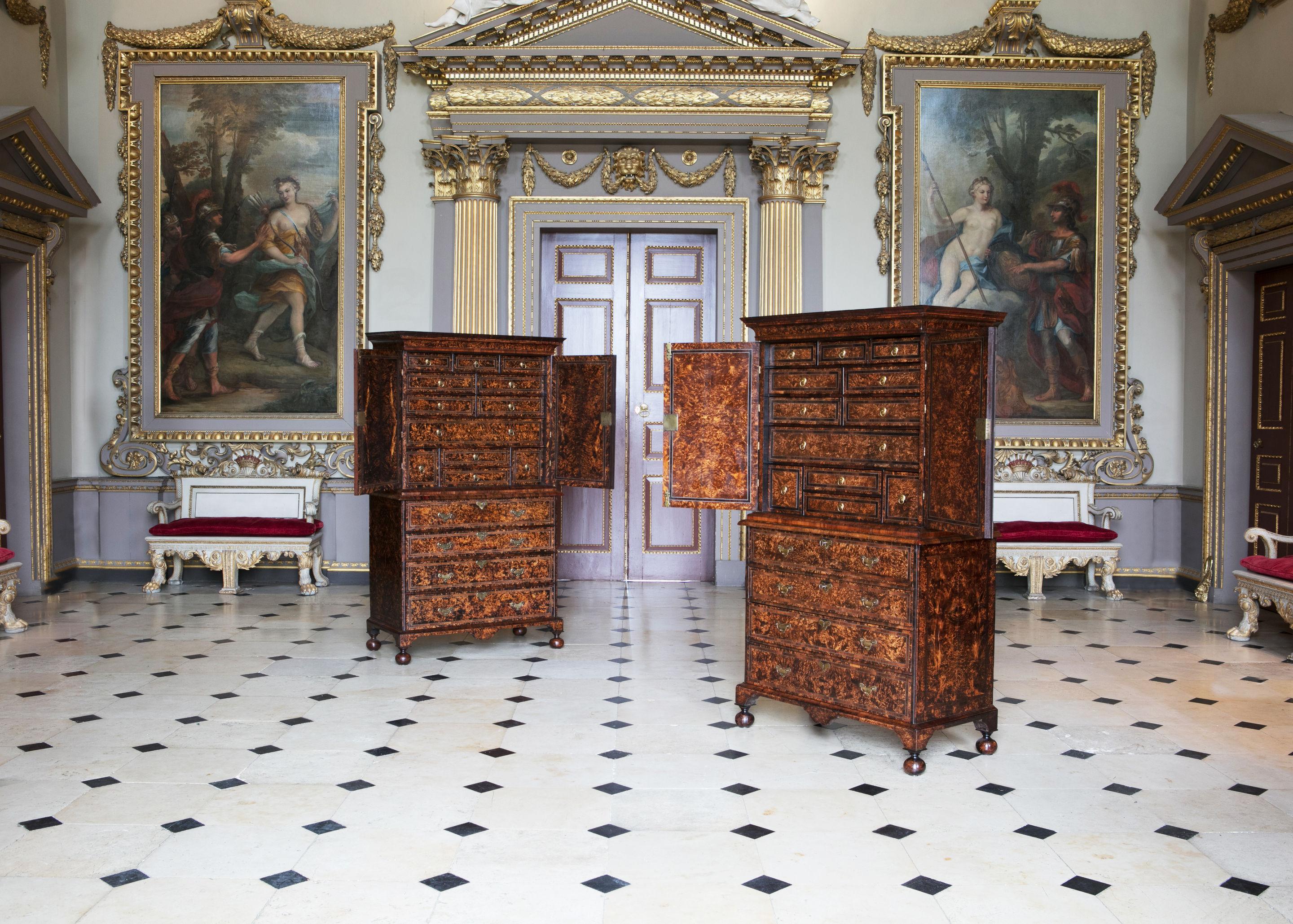 Exceptional English furniture, a unique and important pair of Coxed and Woster 'mulberry' cabinets on secretaire chests, both bearing their original trade labels, circa 1719.

Coxed and Woster are known for their dramatic use of veneers. Burrs