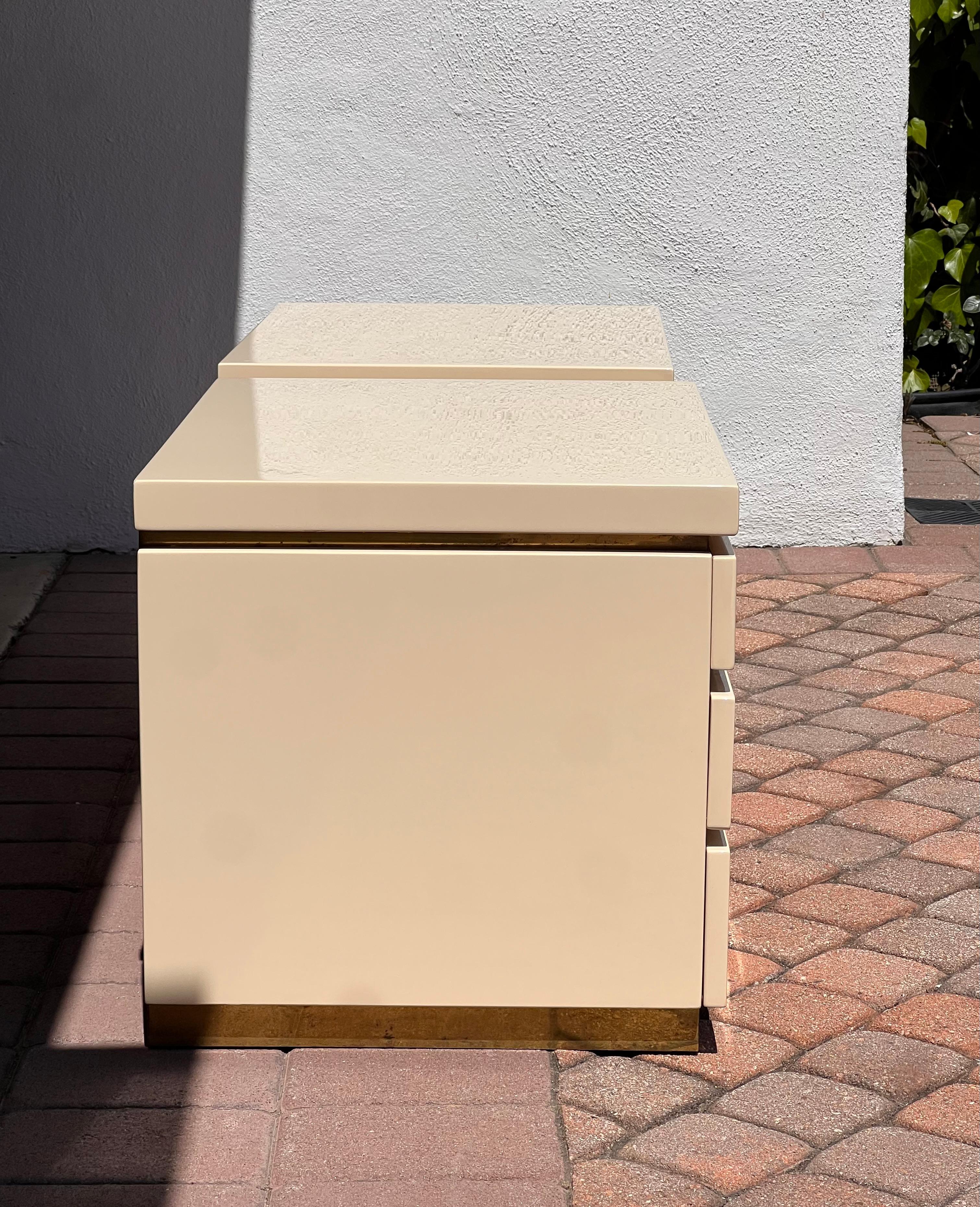 Late 20th Century A pair of cream lacquered nightstands by Jean Claude Mahey, signed, circa 1980 For Sale