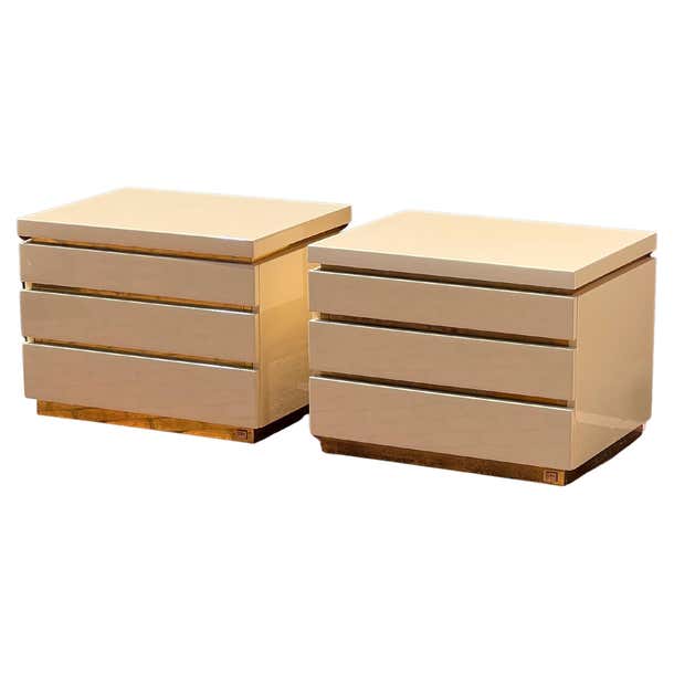 A pair of cream lacquered nightstands by Jean Claude Mahey, signed ...