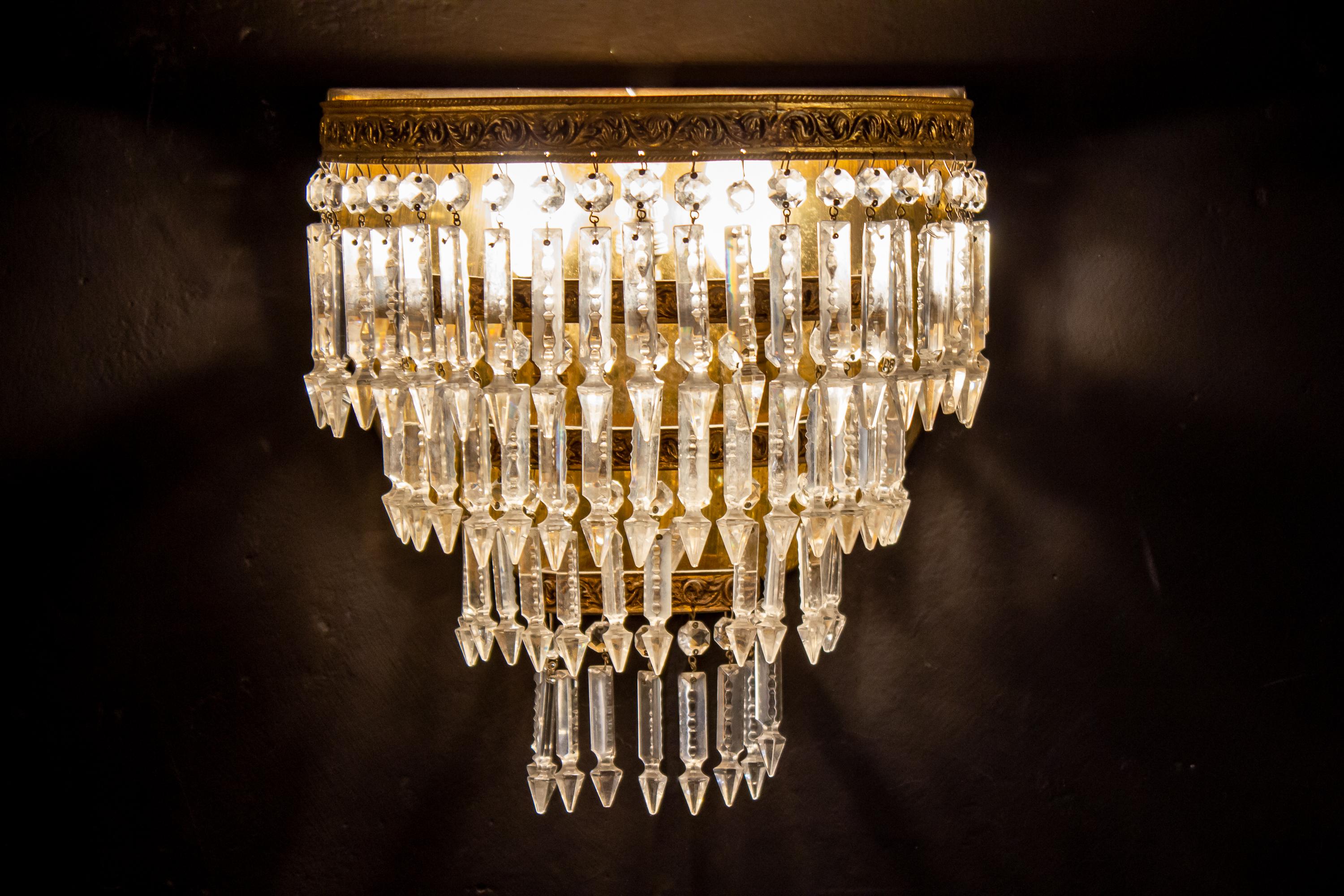 This amazing oval shaped sconces supporting a set of precious cut crystal prisms and octagons on bronze gilded frame.
Three E 14 light bulbs.