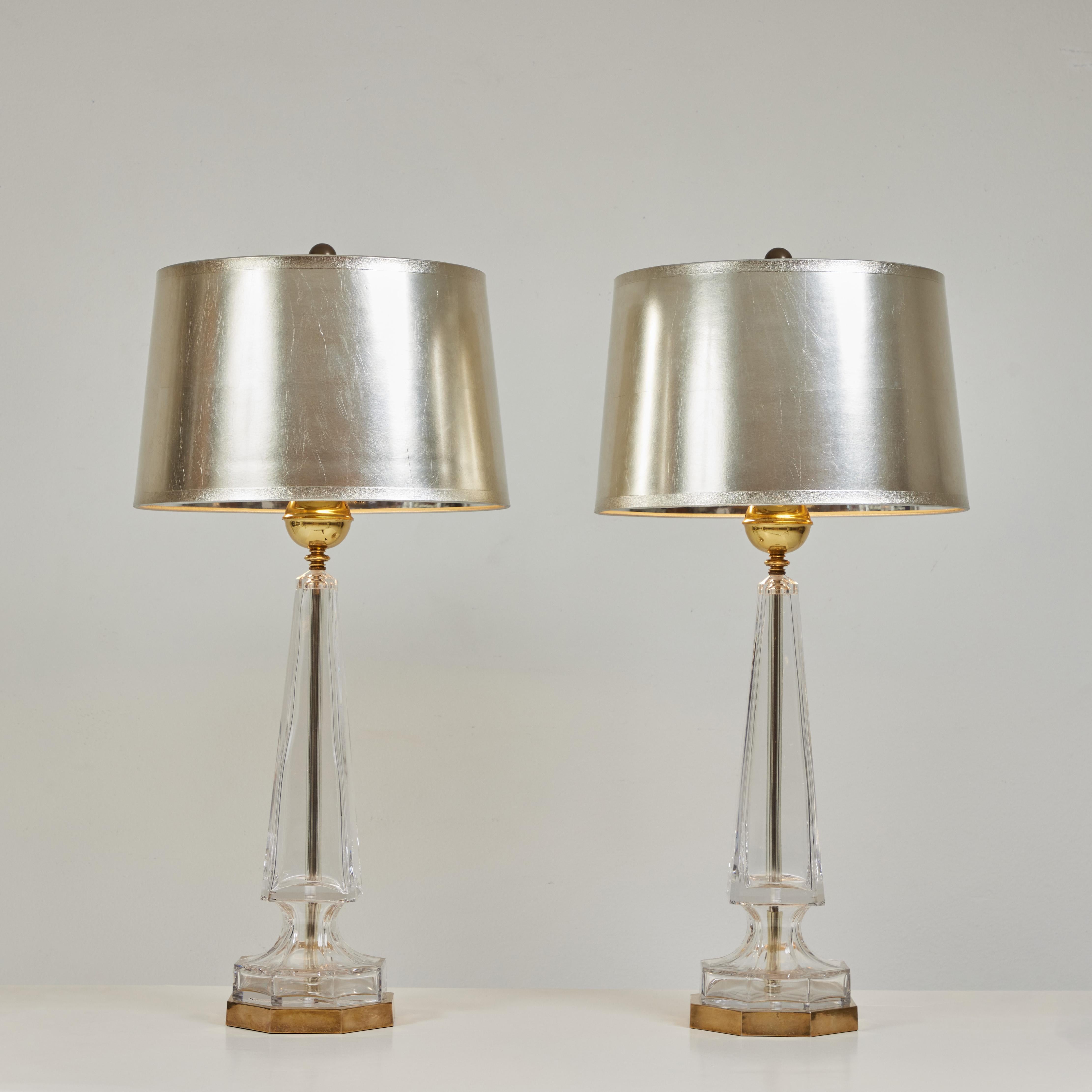 Great pair of moulded crystal lamps by Chapman Lamps, know for their quality product.  The crystal pieces sit on a metal base with a metal rod running up the center of the lamp.  At the top of the Obelisk of each lamp sits a polished and lacquered