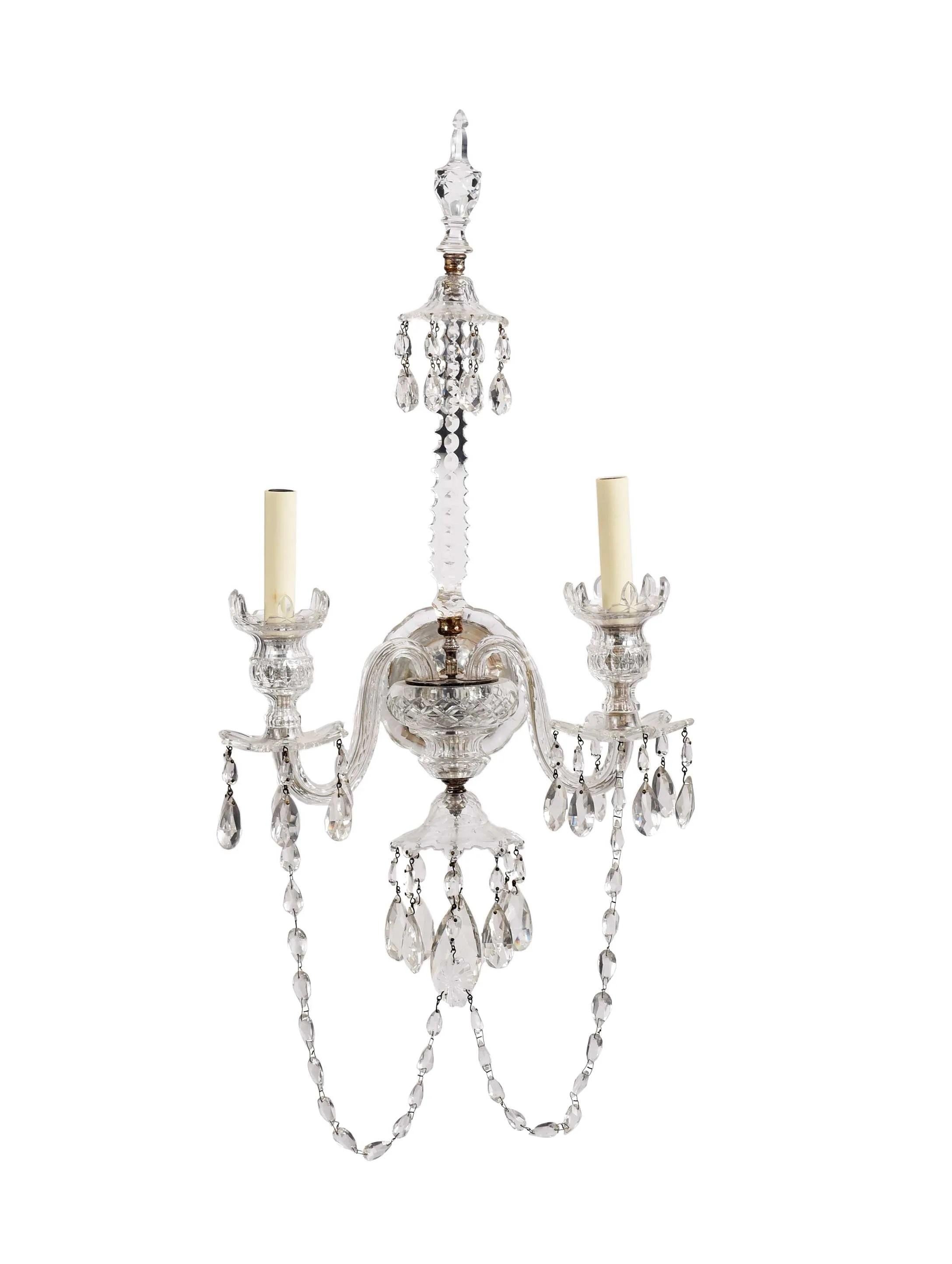 a pair of crystal tow light wall sconces, Nesle Inc., New York, wall mount supporting central column with two S scrolled arms with electric candle lights, surmounted by faceted finial, suspended throughout with drops and garland, wired for