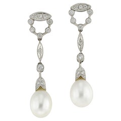 A pair of cultured pearl and diamond drop earrings