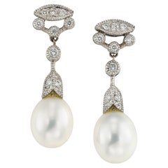 A pair of cultured pearl and diamond drop earrings