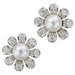 A pair of cultured pearl and diamond flower earrings