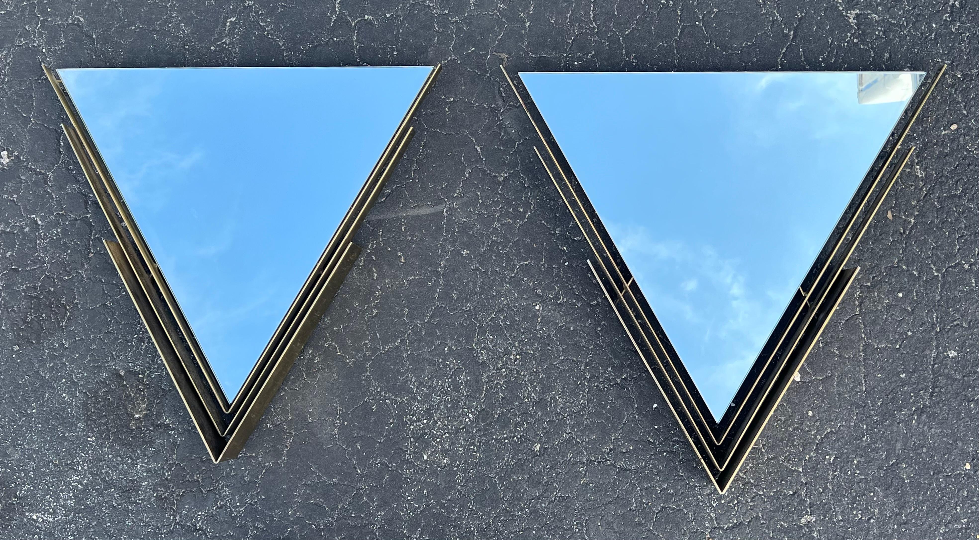 A pair of unusual brass mirrors by Curtis Jere, 1982. Heavy, triangular brass frames. Post modern-Art Deco style. 