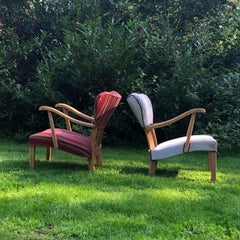 A pair of curved armchairs in solid oak from the 1940s.