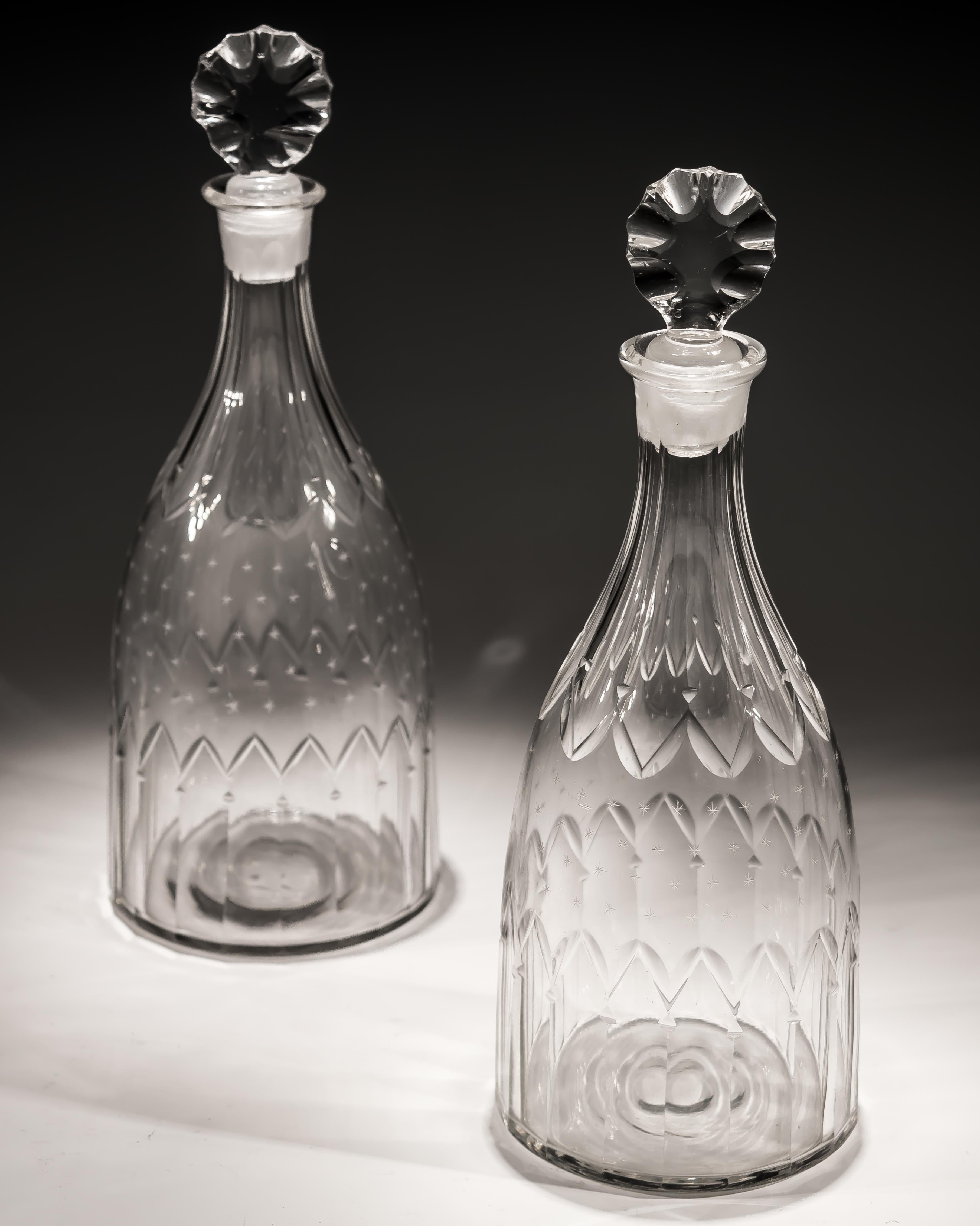 A pair of cut glass 18th century tapered decanters finely engraved with stars.