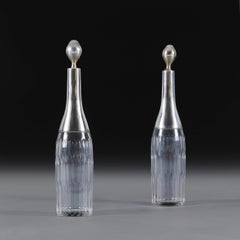 A Pair of Cut Glass and Silver Wine Decanters