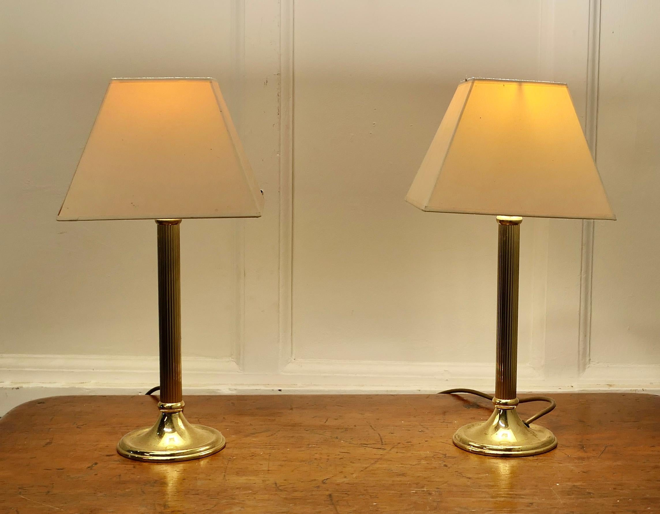A pair of Dainty Brass Corinthian Column Bedside Lamps with Shades

These are a very attractive pair of lamps they have a single corinthian style column set on a round base, they have square fabric shades
The lamps are in good condition, working and