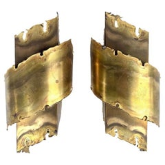 A pair of Danish 1960s Holm Sorensen torch cut brass wall sconces