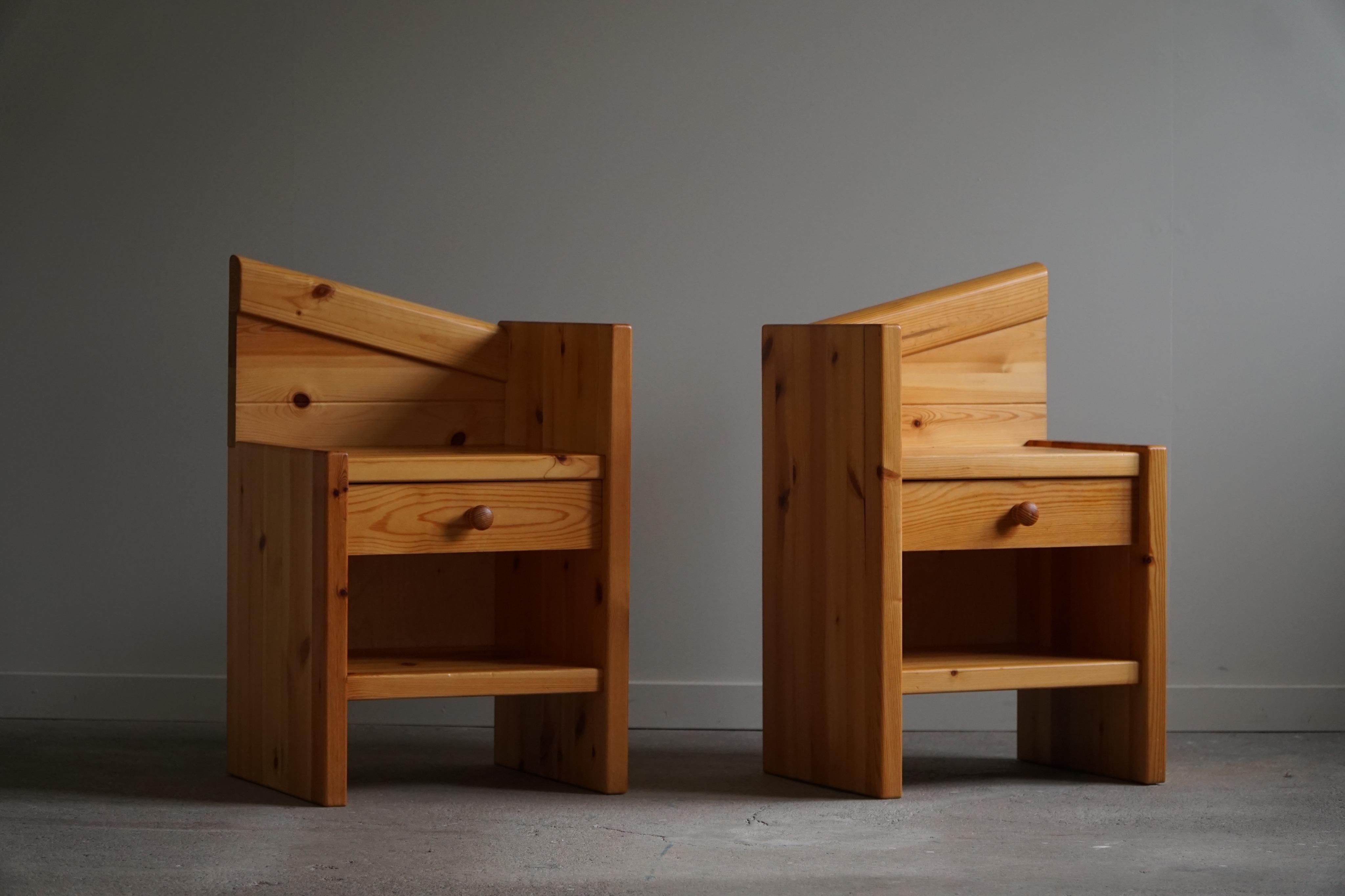 A pair of Scandinavian night stands / side tables in pine, made in Denmark, circa in 1970s by an unknown cabinetmaker. These night stands come with drawers and some angled corners. 

The night stands are nicely patinated with some traces of