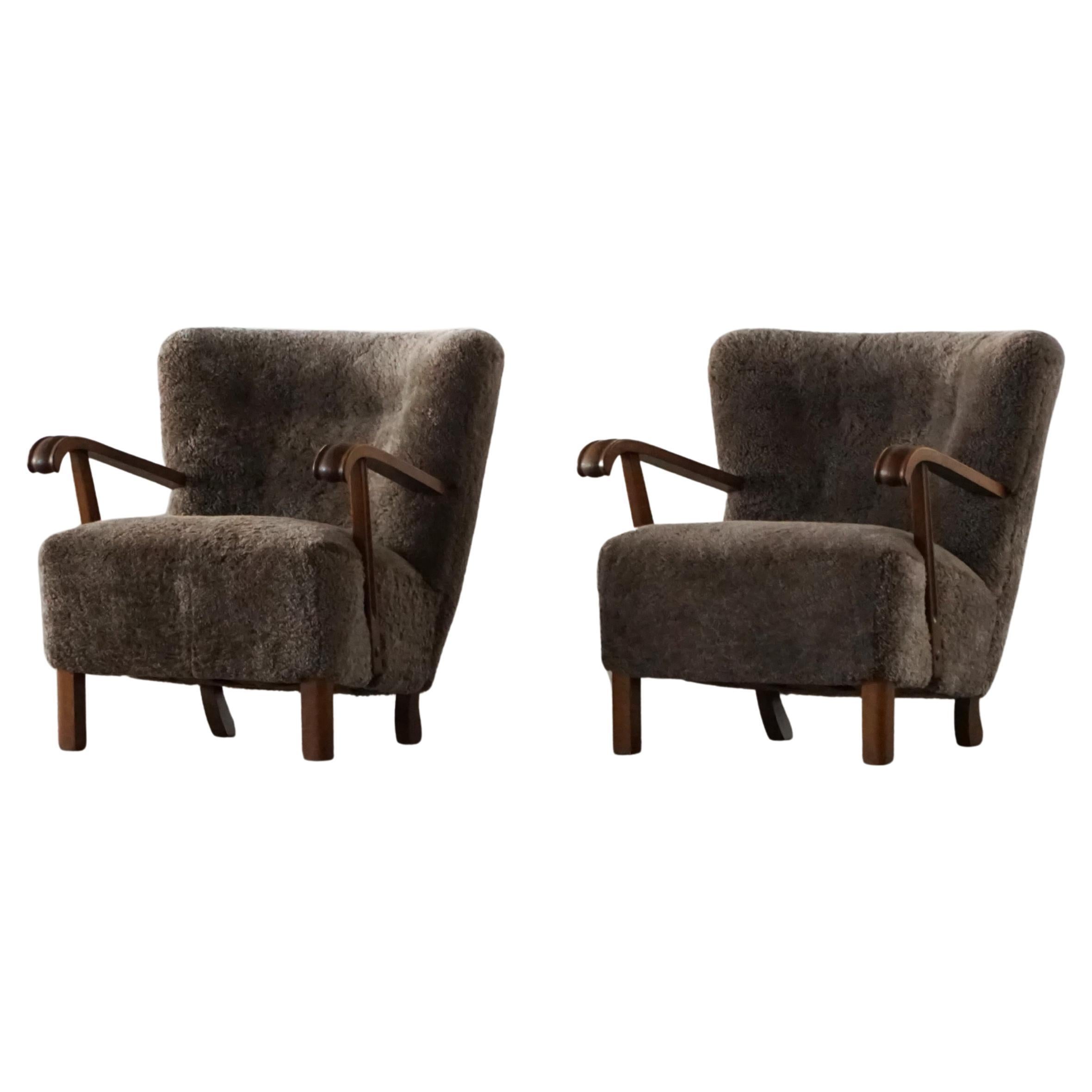 A Pair of Danish Mid Century Modern Lounge Chairs in Beech 
Lambswool, 1950s