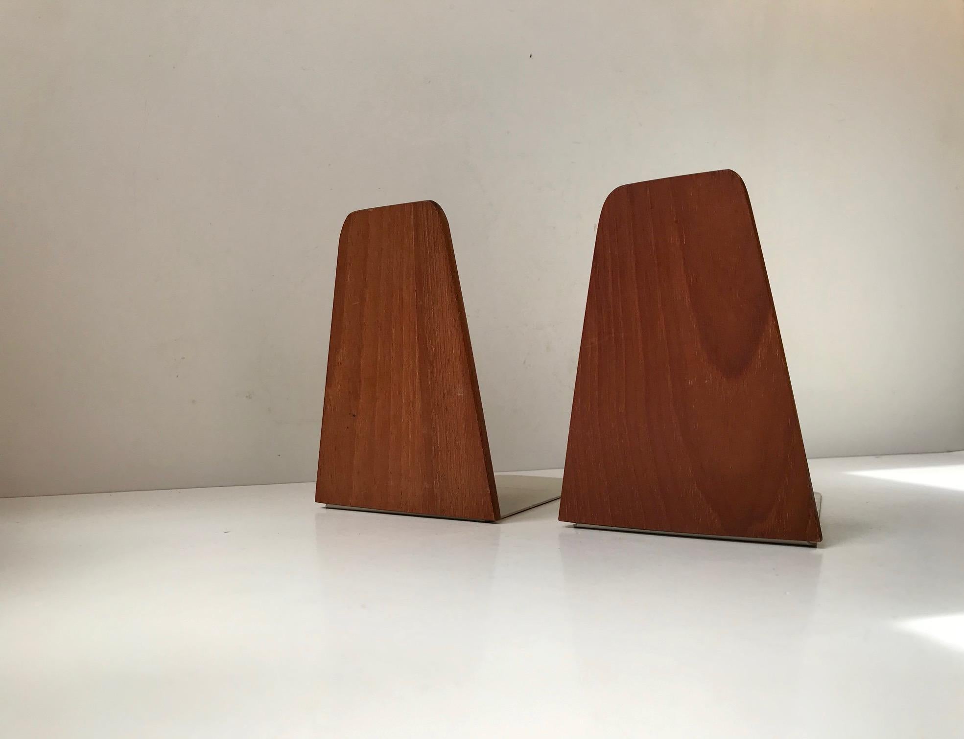 A set of 2 bookends in teak with steel rests. Designed by Kai Kristiansen and manufactured by FM Møbler in Denmark during the 1960s. These are the largest of two sizes.