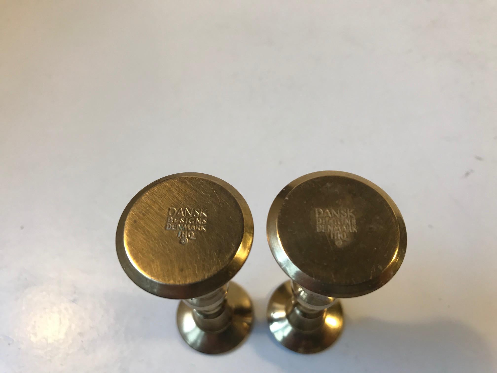 A pair of miniature candlesticks in engine turned solid brass. These are rare and was designed in the late 1950s by Danish Industrial design icon Jens Harald Quistgaard (IHQ). They are to be used with thin and long candles. Both of them fully marked