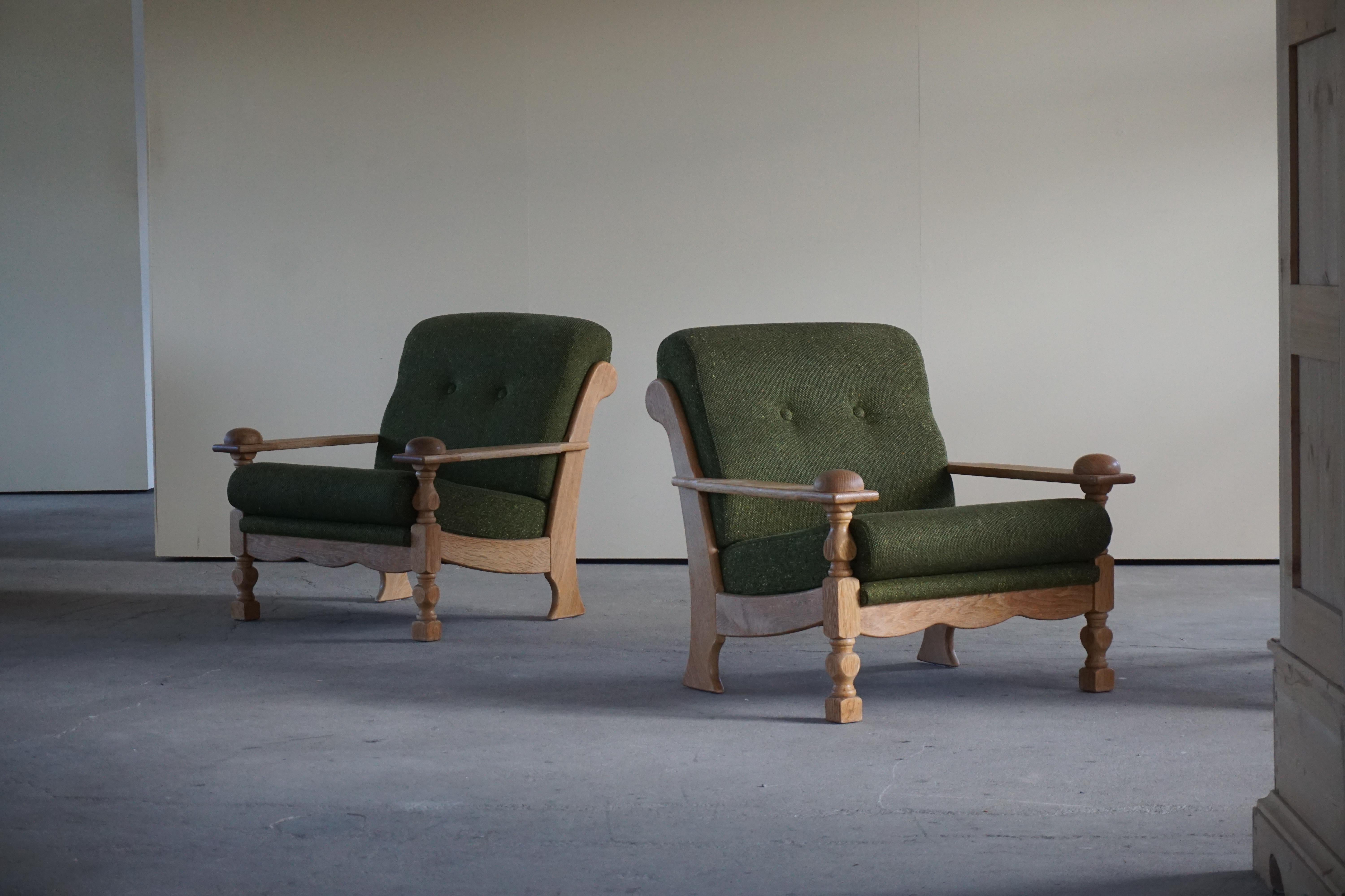 A pair of Danish Modern lounge chairs in style of Henning Kjærnulf. Made in oak and green wool. 1970s
The armchairs are in a good original vintage condition.