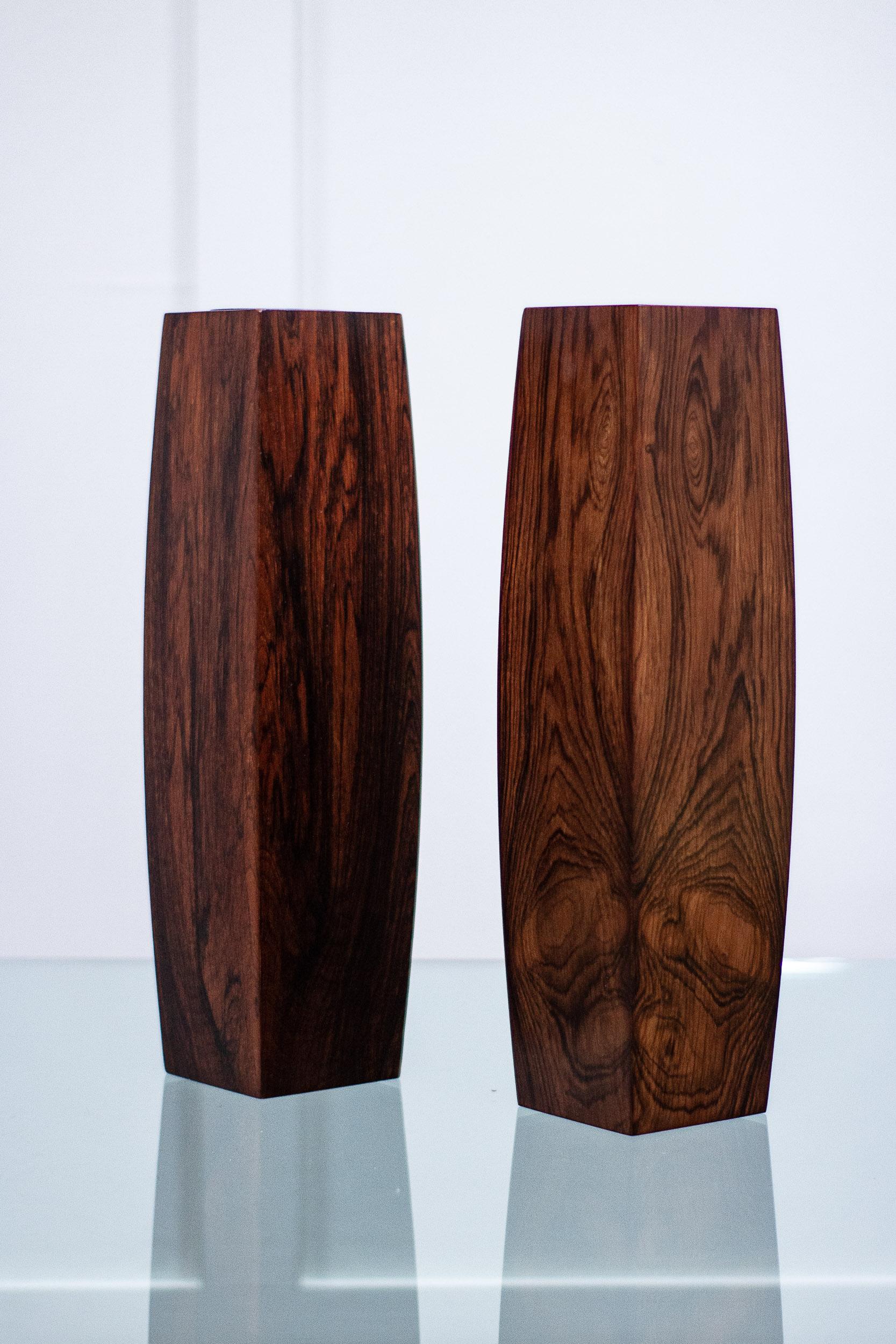 A pair of Danish rosewood vases, 1960s. 

The vases are made of ply with a rosewood veneer and a plastic internal cylinder. 

Makers mark stamped on the base, but unreadable.