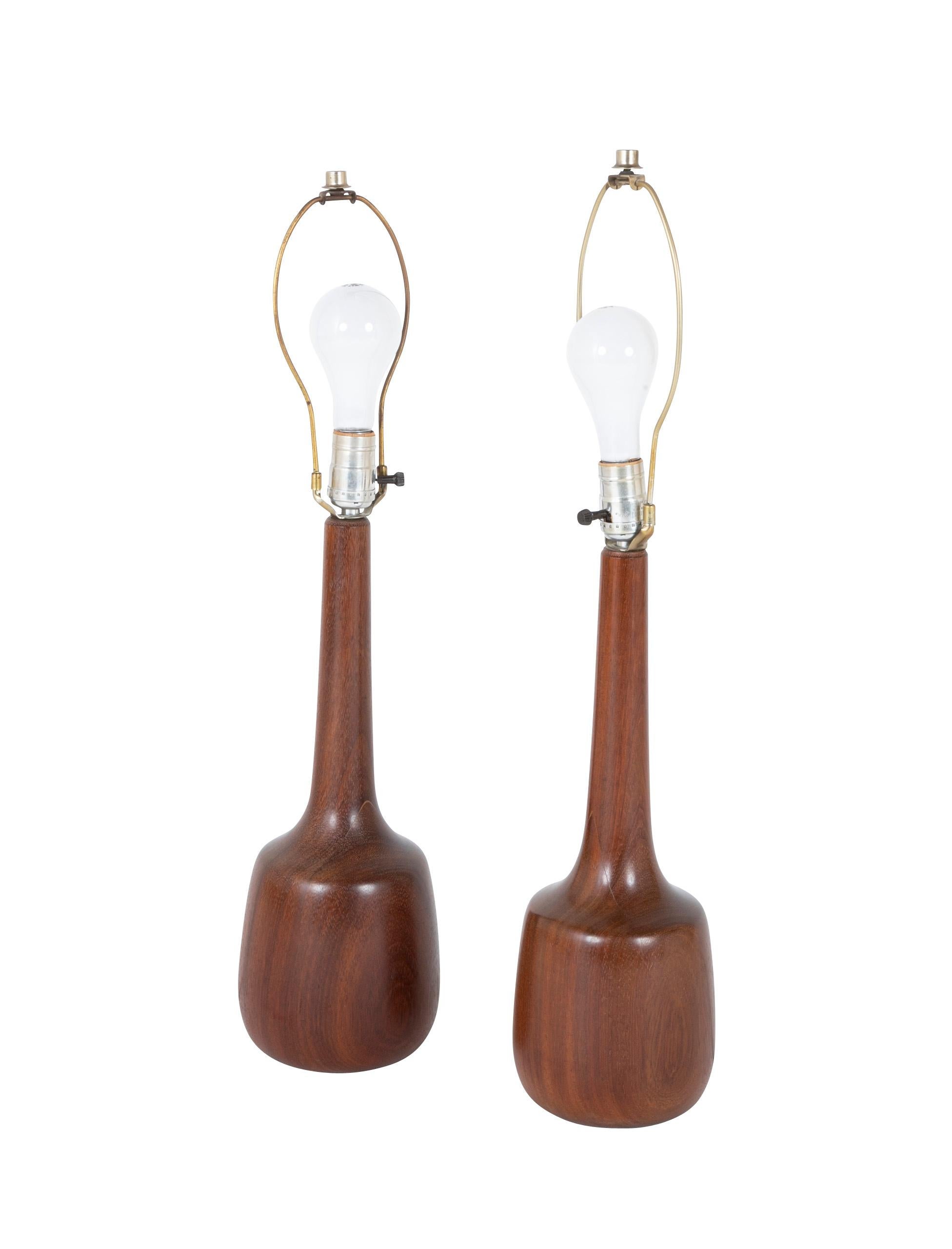 A pair of Danish solid mahogany MCM lamps. Circa 1960's.