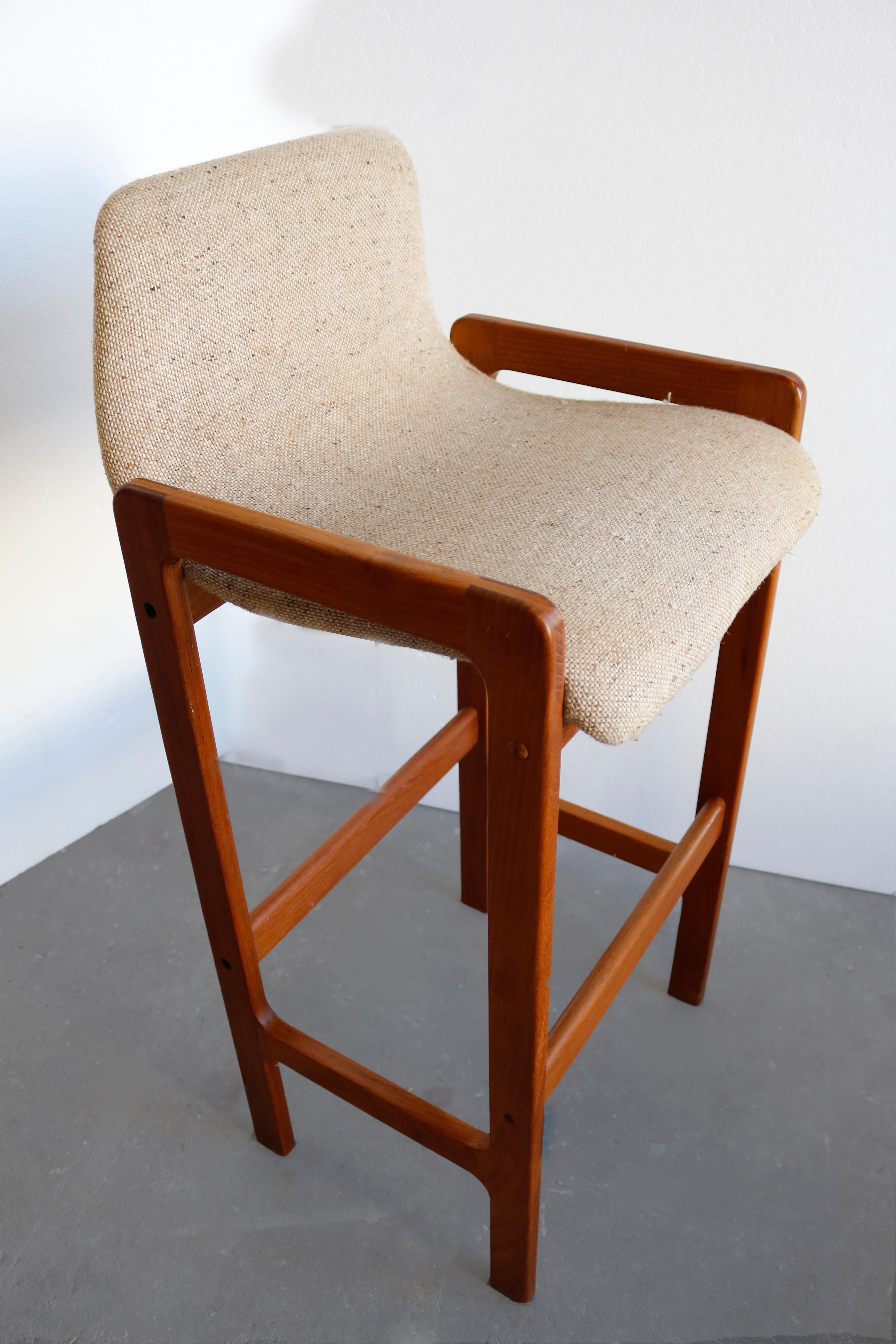 Comfy, Danish bar stools framed in teak wood and upholstered in tweed wool upholstery.