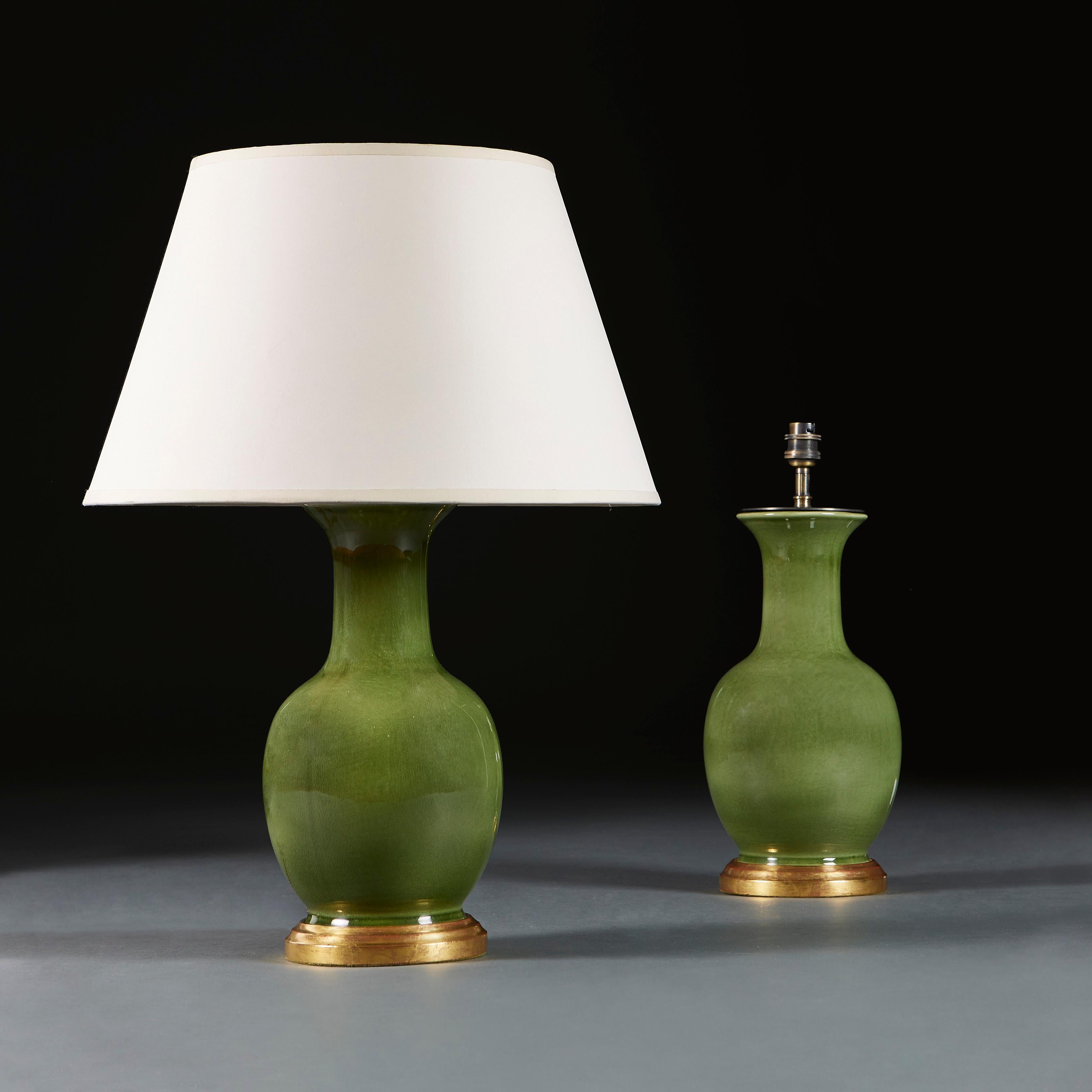 China, circa 1900

A pair of late nineteenth century Chinese bottle neck vases with dark Celadon glaze, now mounted as lamps with turned gitlwood bases.

Height 33.00cm
Height with shade 57.00cm
Diameter of base 14.00cm.

Please note: This is