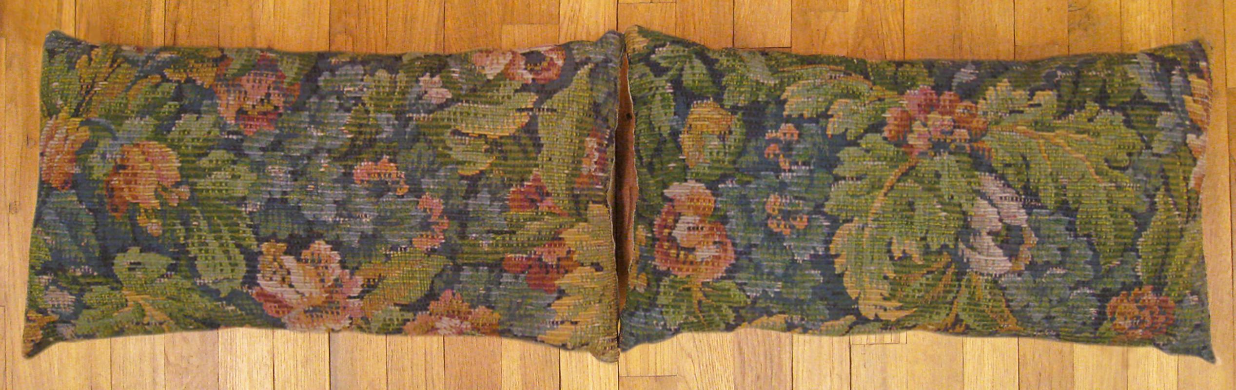A pair of antique jacquard tapestry pillows ; size 1'0” x 2'0” each.

An antique decorative pillows with floral elements allover a blue green central field, size 1'0