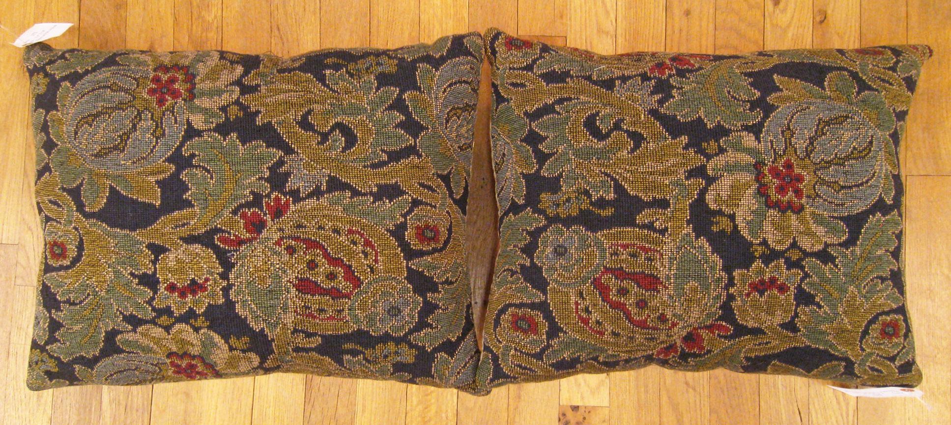 A pair of antique jacquard tapestry pillows ; size 1'5” x 1'8” each.

An antique decorative pillows with floral elements allover a gray green central field, size 1'5