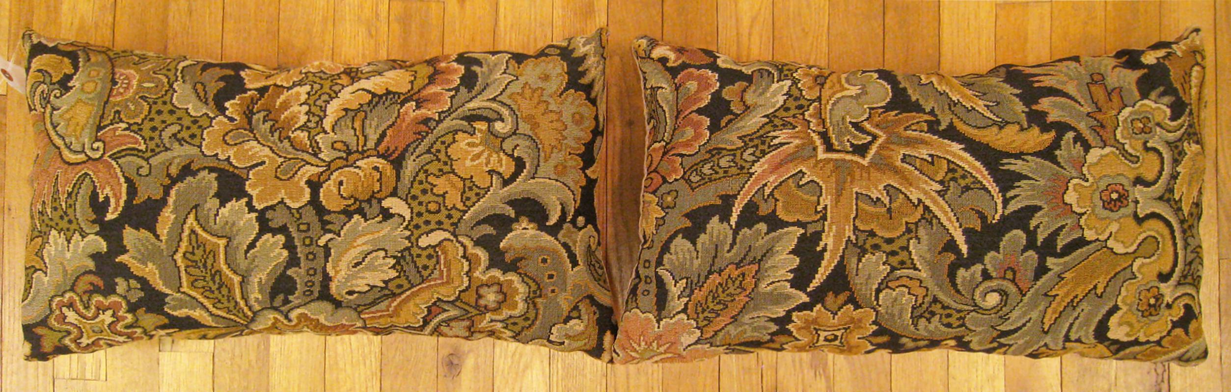 A pair of antique jacquard tapestry pillows ; size 1'2” x 2'0” each.

An antique decorative pillows with floral elements allover a gold green central field, size 1'2