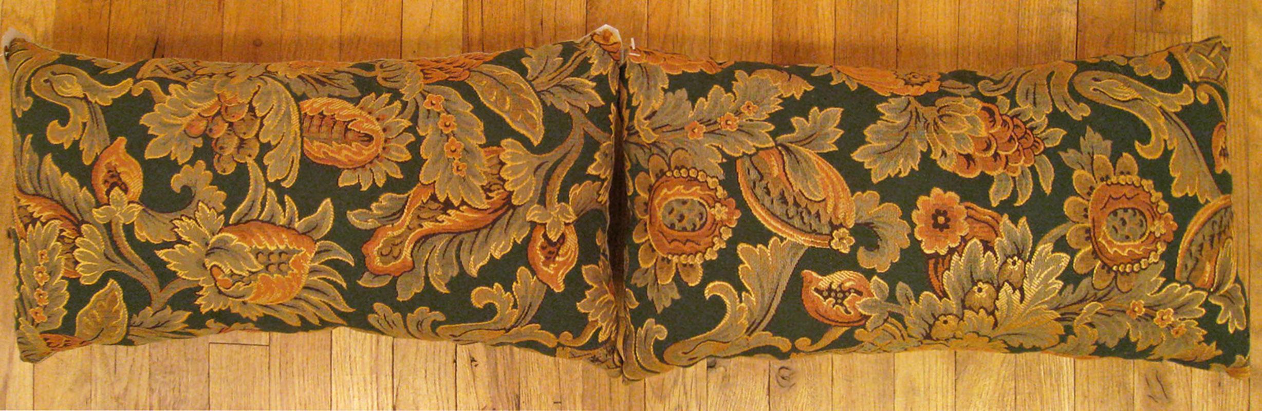 A pair of antique jacquard tapestry pillows ; size 1'0” x 1'11” each.

An antique decorative pillows with floral elements allover a gold green central field, size 1'0
