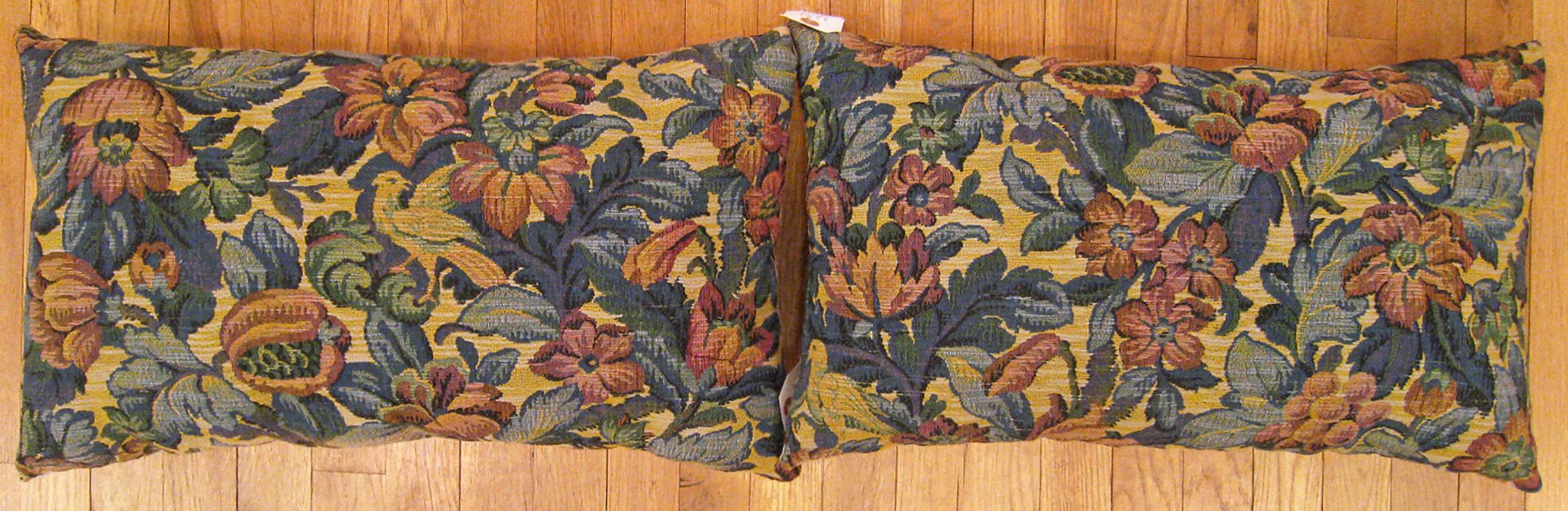 A pair of antique jacquard tapestry pillows ; size 1'2” x 2'0” each.

An antique decorative pillows with floral elements and birds allover a blue green central field, size 1'2