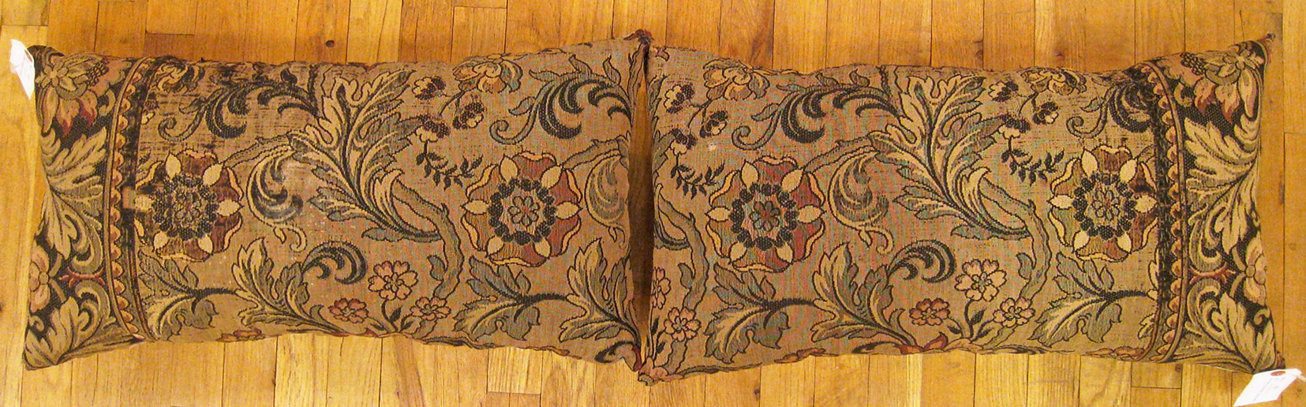 A pair of antique jacquard tapestry pillows ; size 1'3” x 2'2” each.

An antique decorative pillows with floral elements allover a brown central field, size 1'3